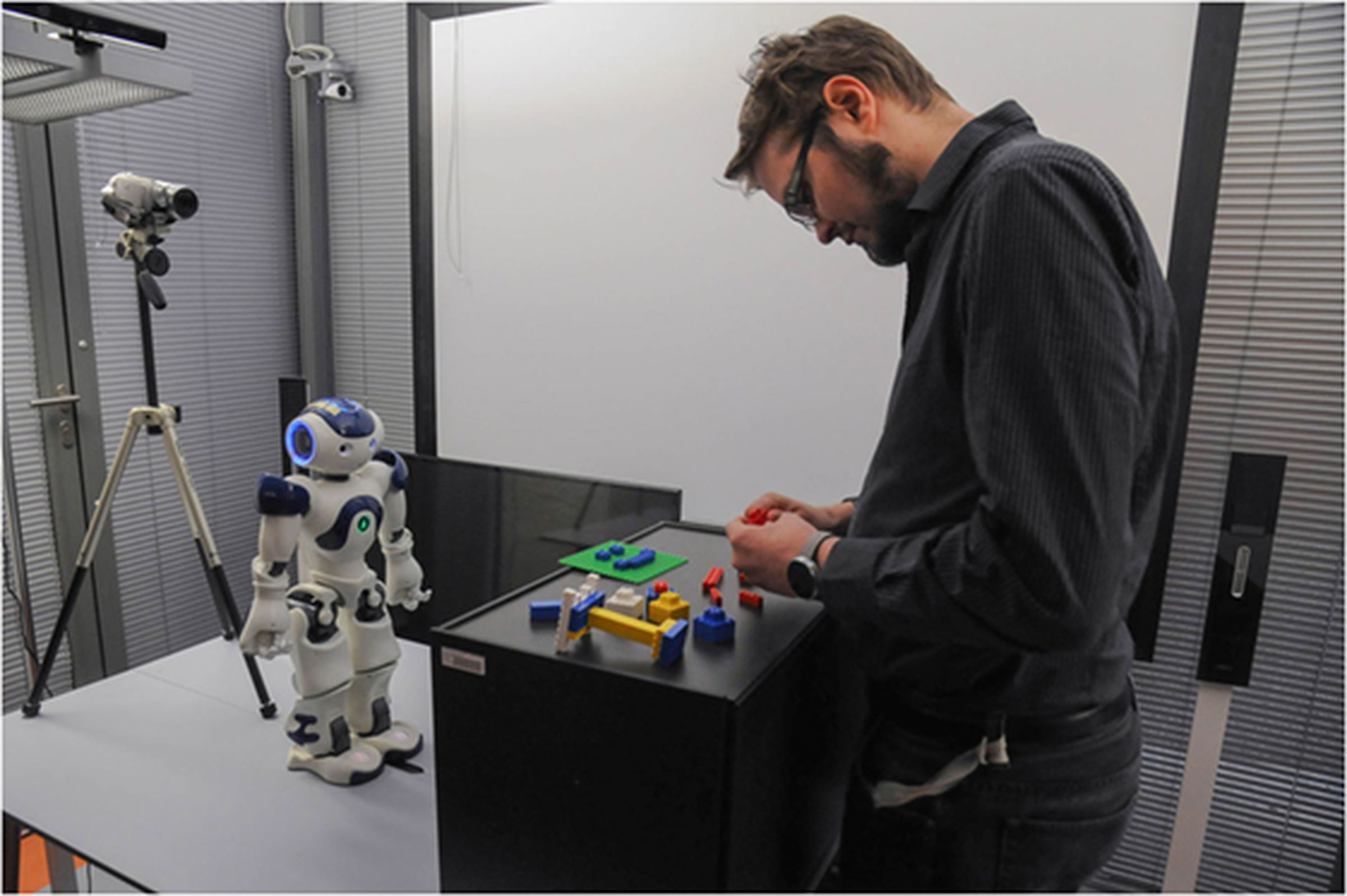 The experiment in Salzburg asked human volunteers to build LEGO creations with help from a robot. Participants were filmed to study their reactions. 