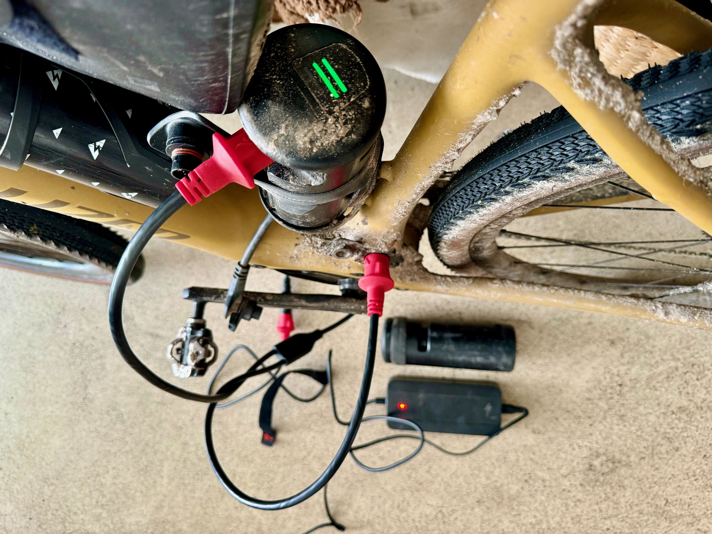 <em>Specialized’s Y-Cable charging both the main battery and one range extender. On the floor you can see the charging brick next to second range extender.</em>
