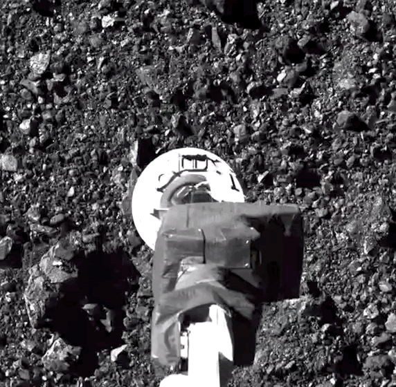 Osiris-REx’s sampling arm plucks a sample from the Bennu asteroid on October 20th, 2020.