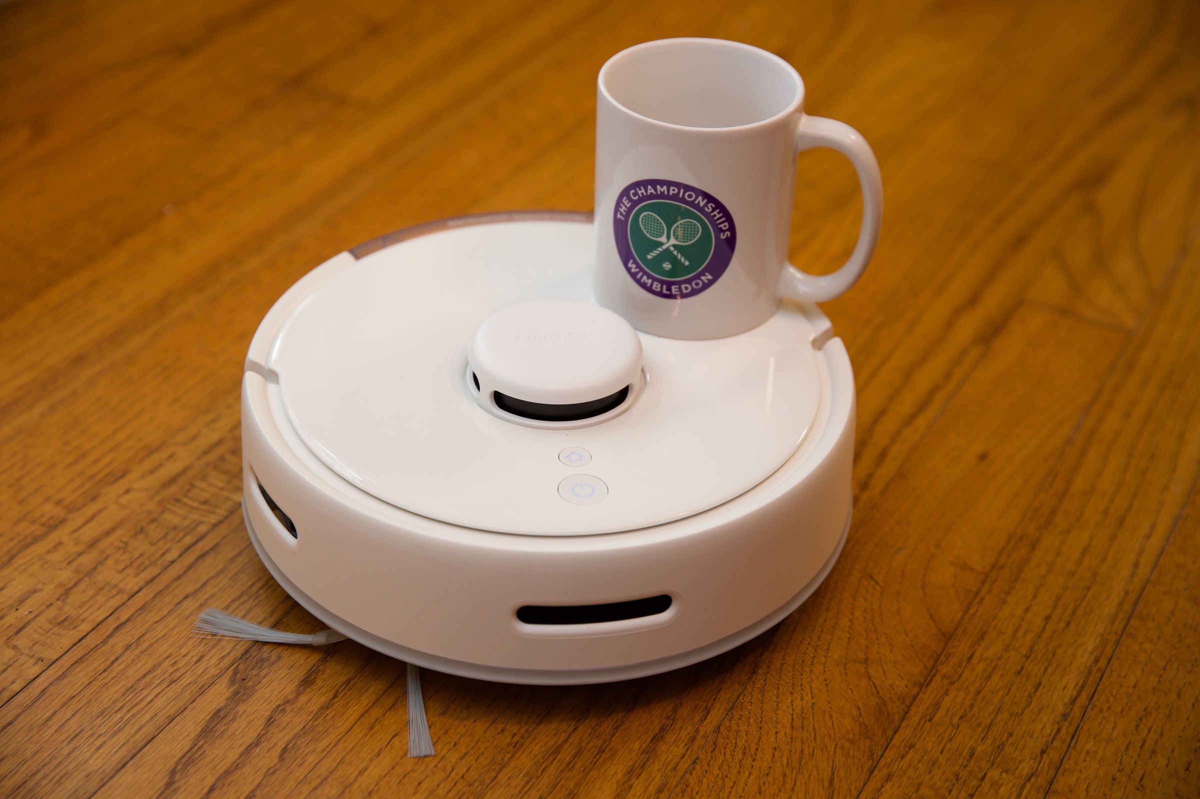 <em>Mug for size, the SwitchBot k10 is very small.</em>