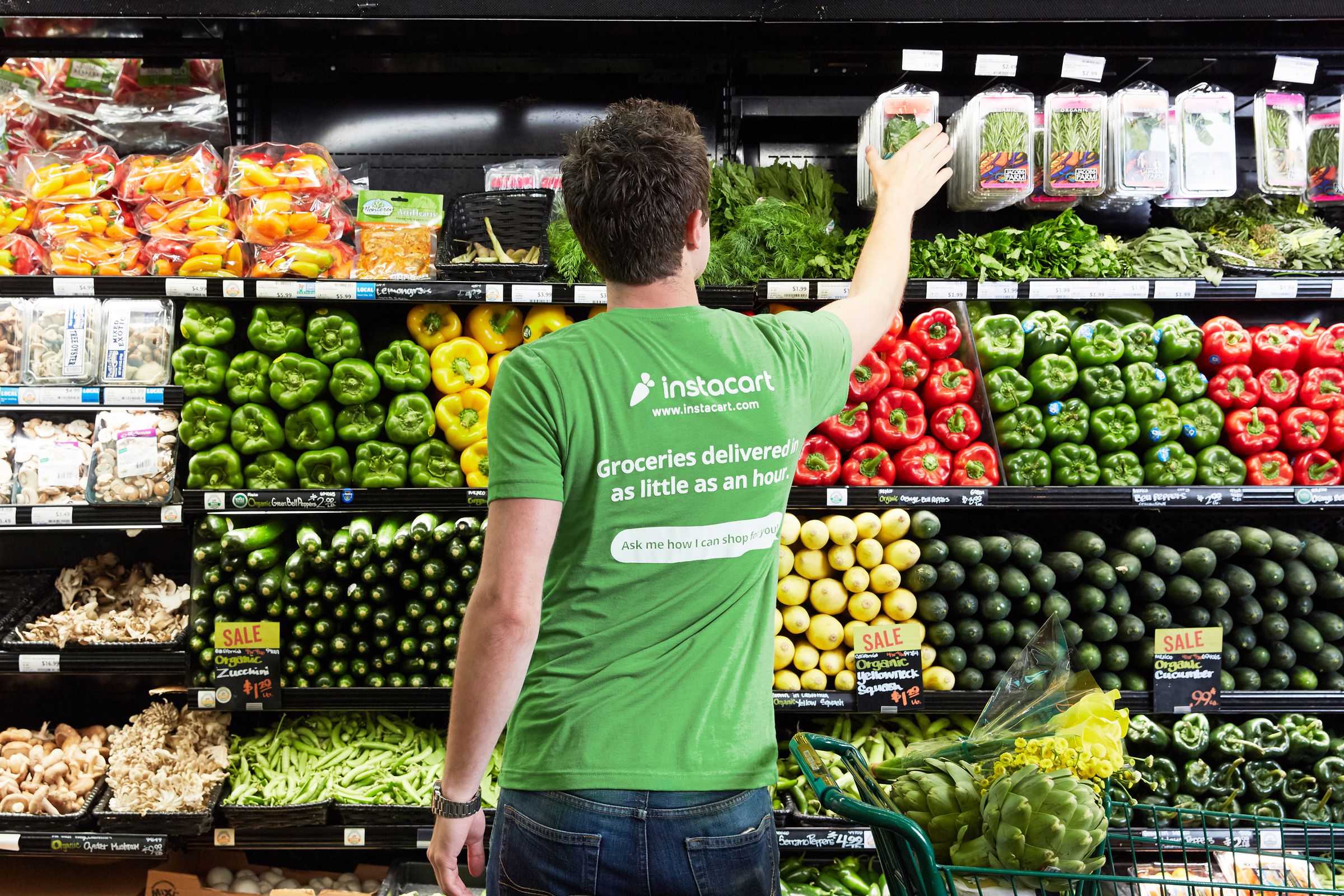 An Instacart shopper chooses items for a grocery order.