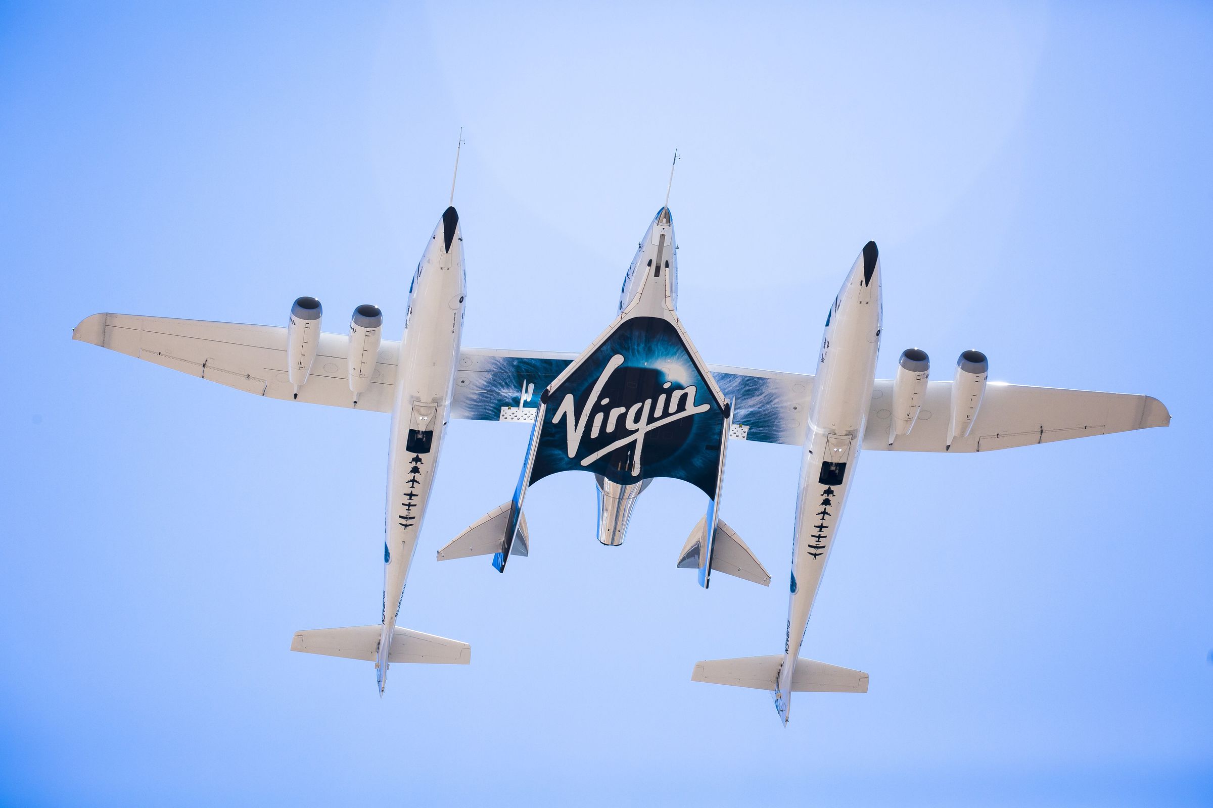 Virgin Galactic’s SpaceShipTwo spaceplane is carried between the two fuselages of its WhiteKnight carrier aircraft during a 2016 test.