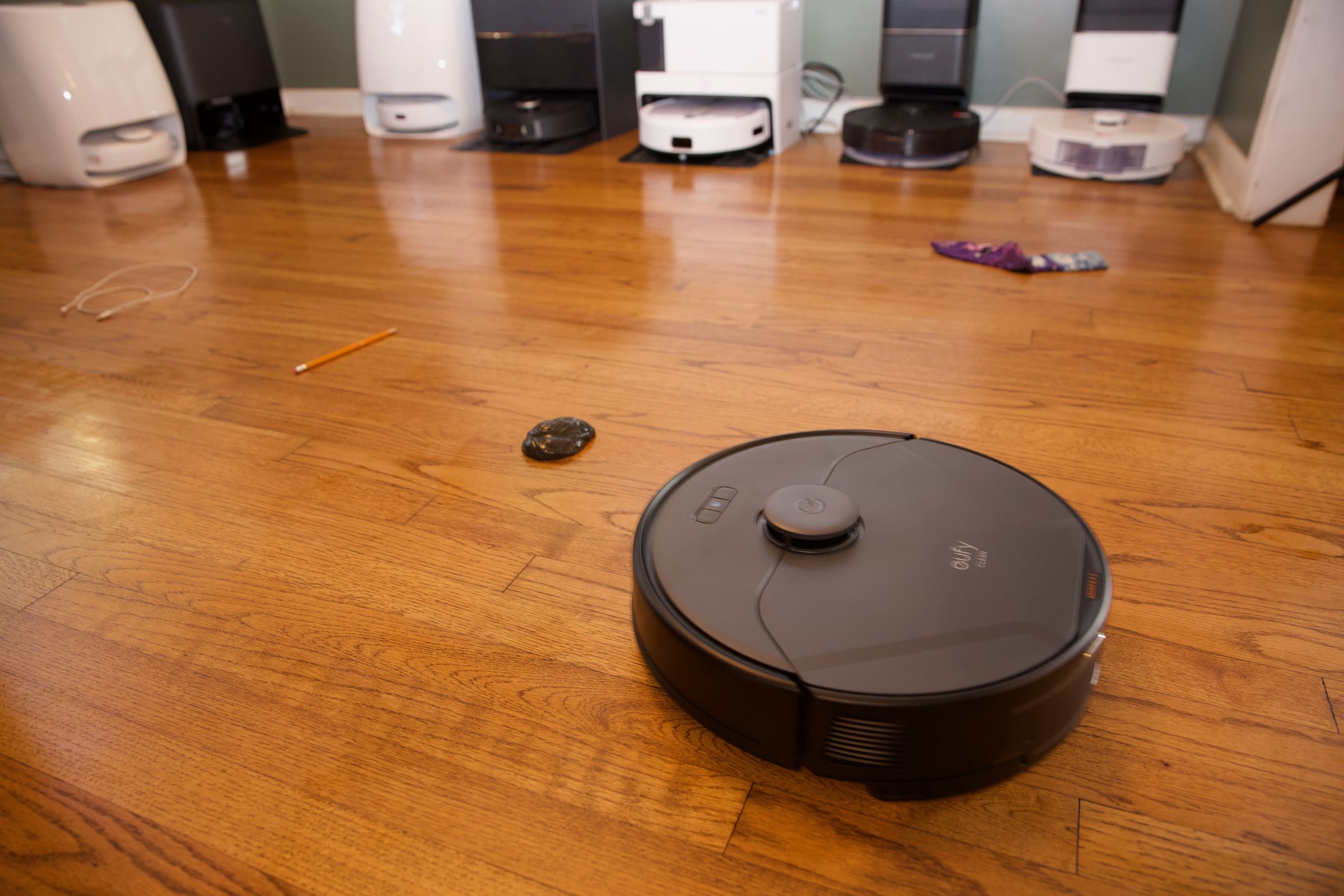 An Eufy robot vac running the gauntlet in my test lab / sitting room.