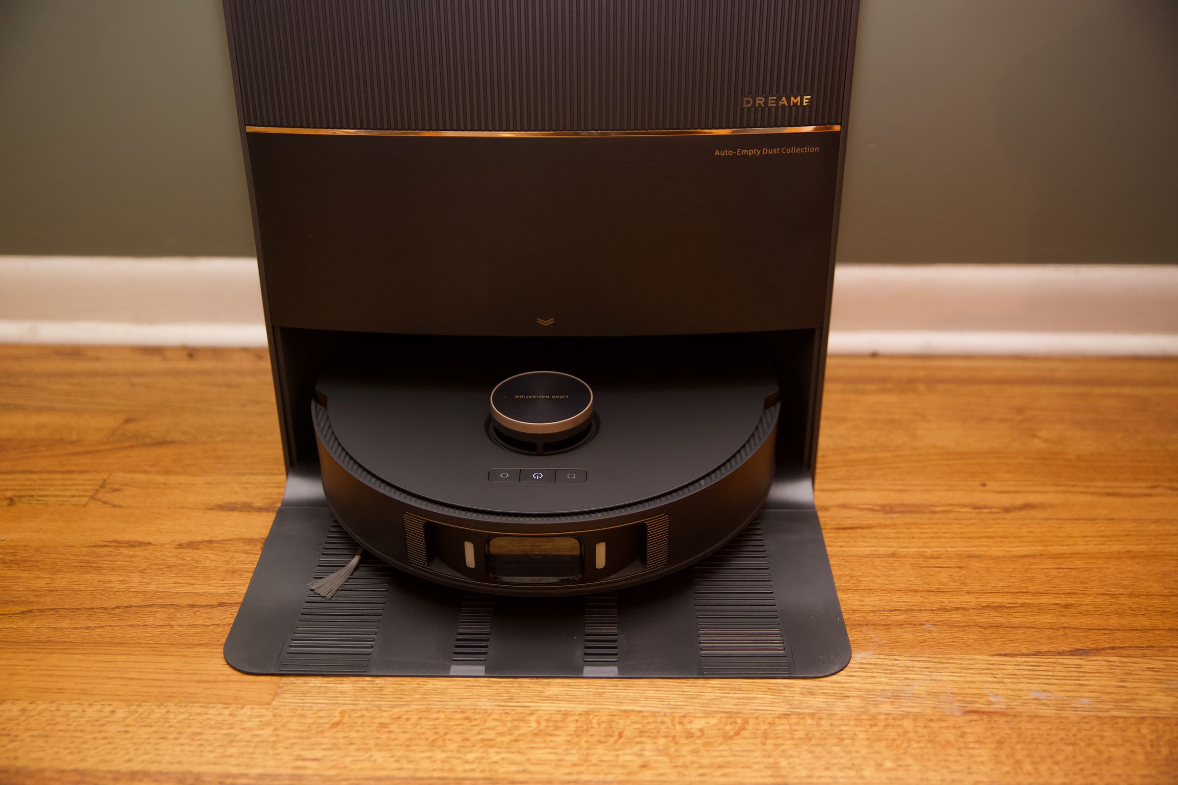 The DreameBot L20 Ultra robot vacuum and mop sitting docked in its auto-emptying station.