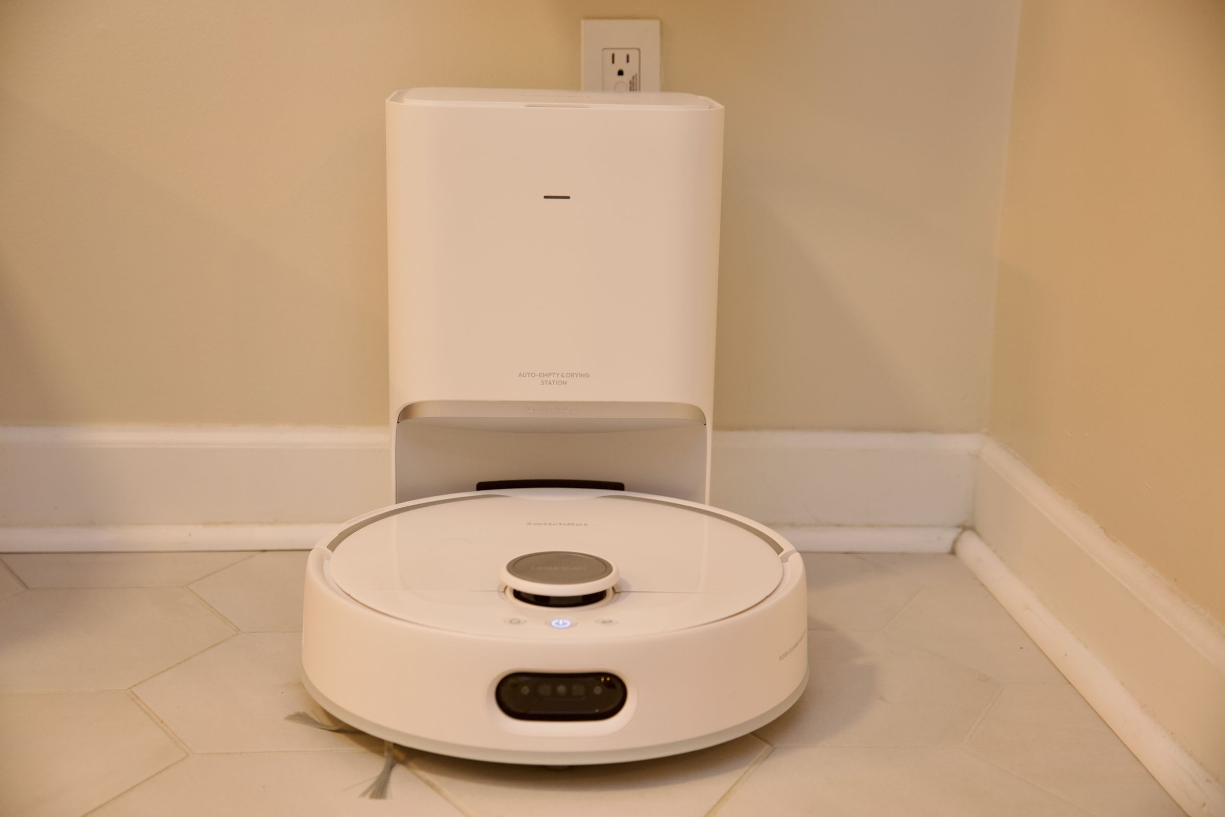 The separate charging dock empties the robot’s bin and dries its mop.