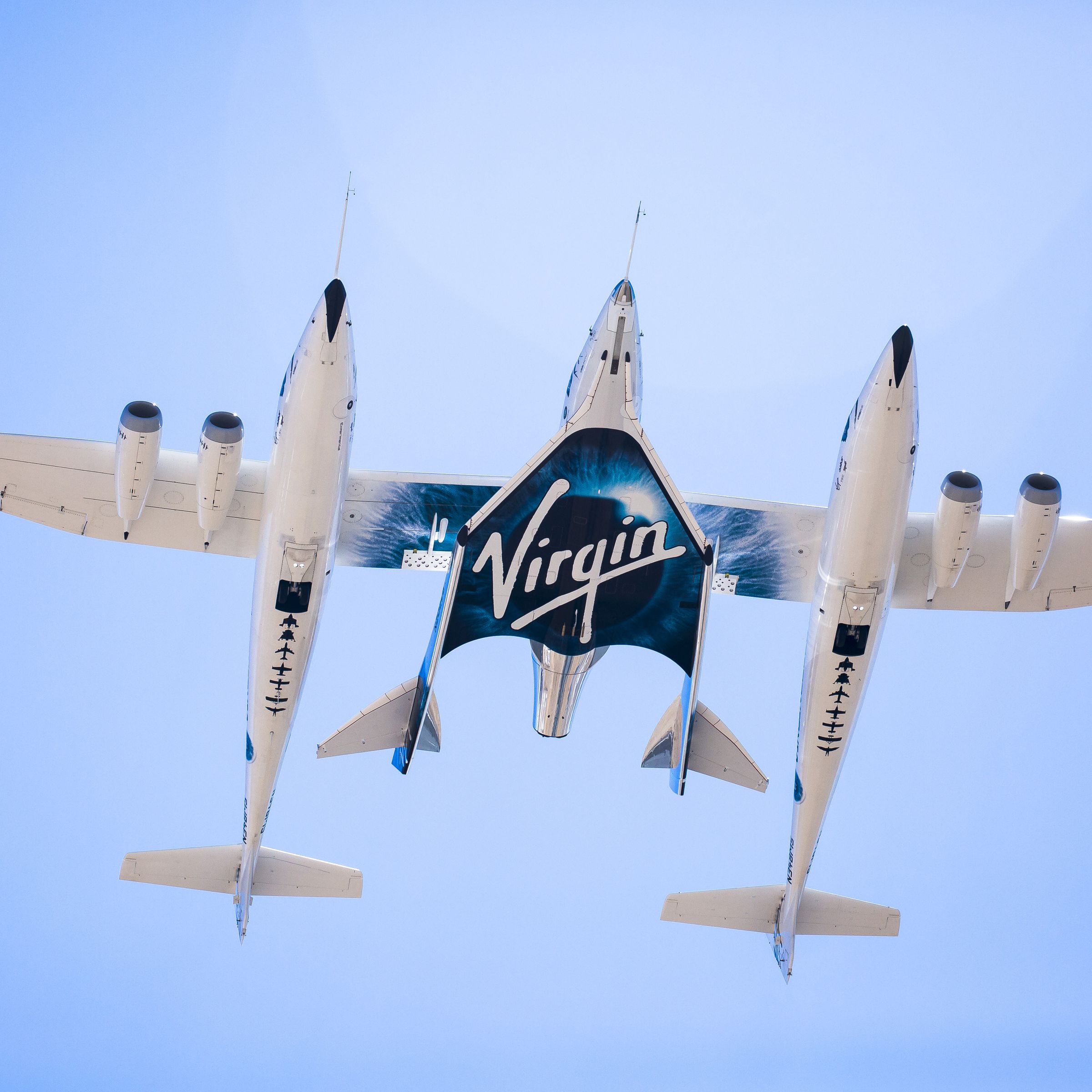 Virgin Galactic’s SpaceShipTwo spaceplane is carried between the two fuselages of its WhiteKnight carrier aircraft during a 2016 test.