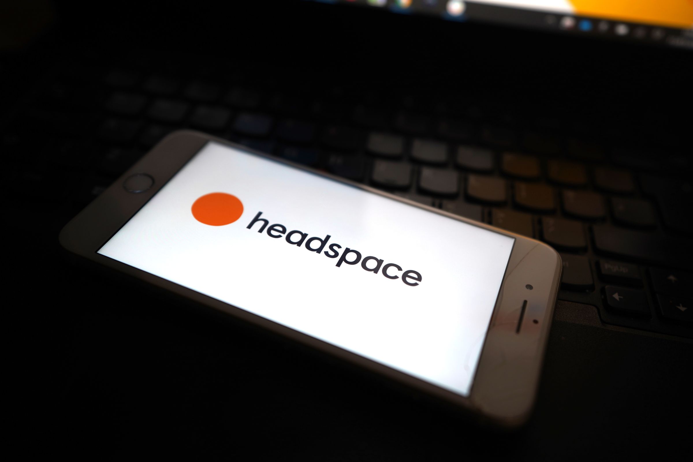 The Headspace logo seen on an iPhone screen.