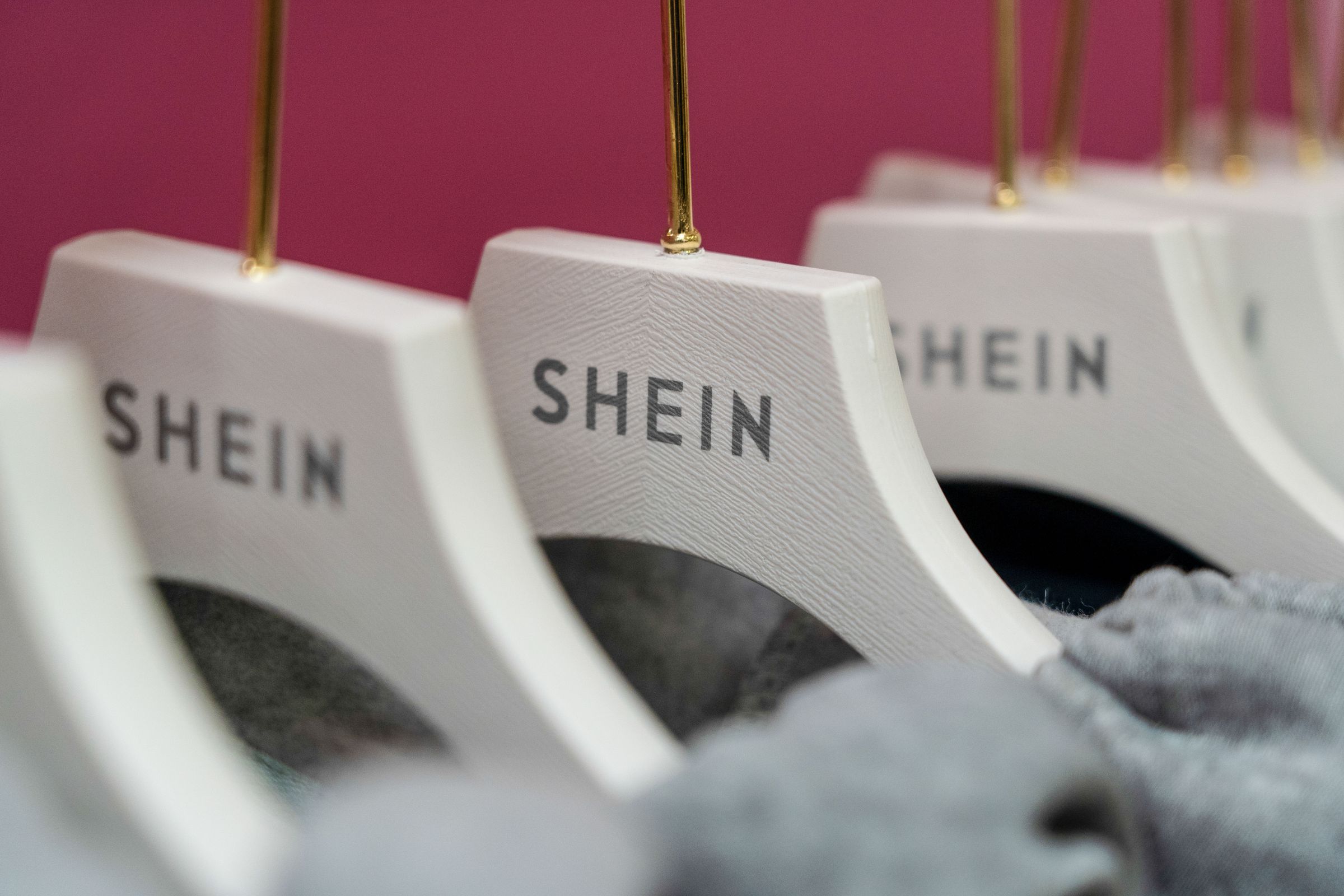 A rack of clothing with Shein-branded hangers