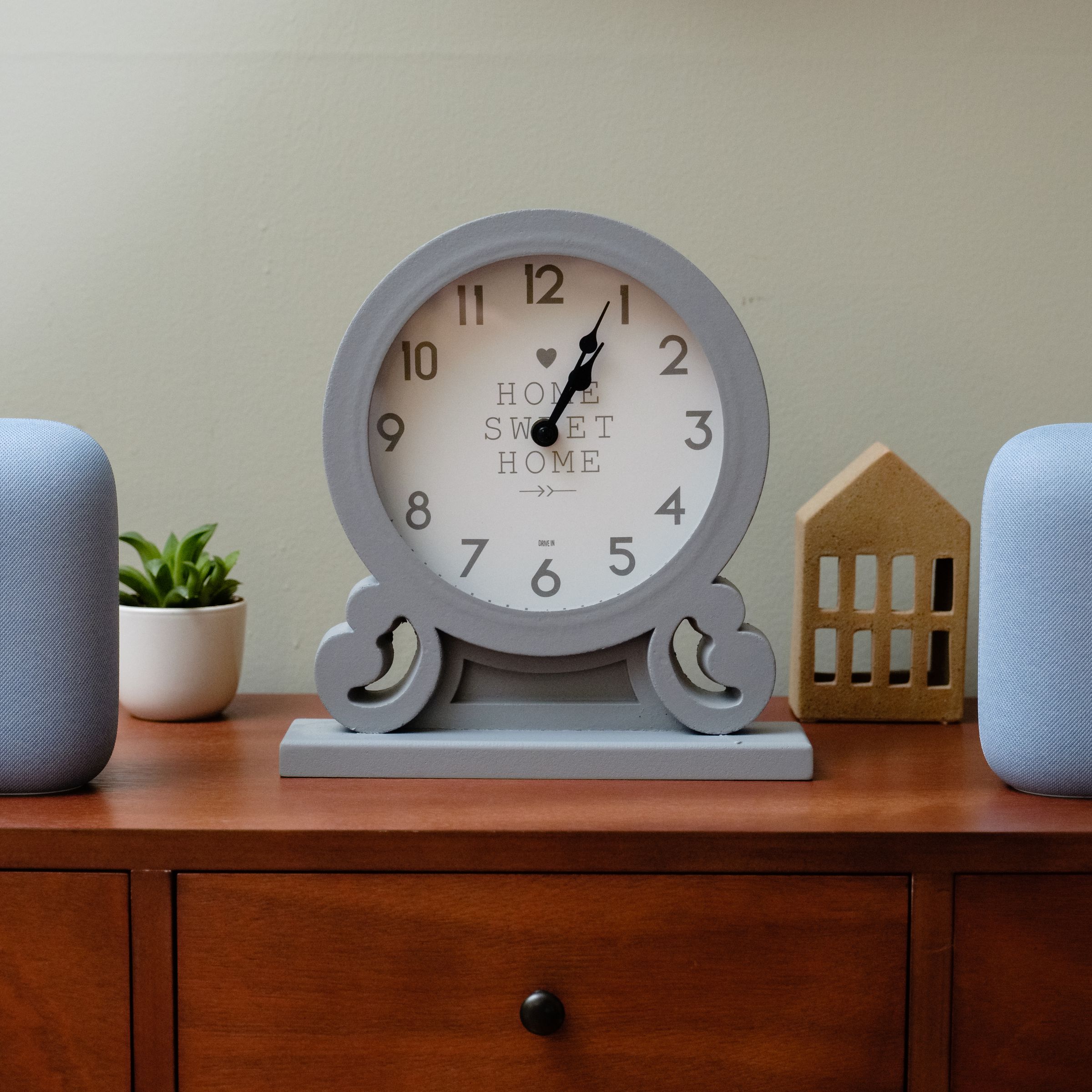 A picture of two Google Nest Audio speakers sitting on a piece of furniture.