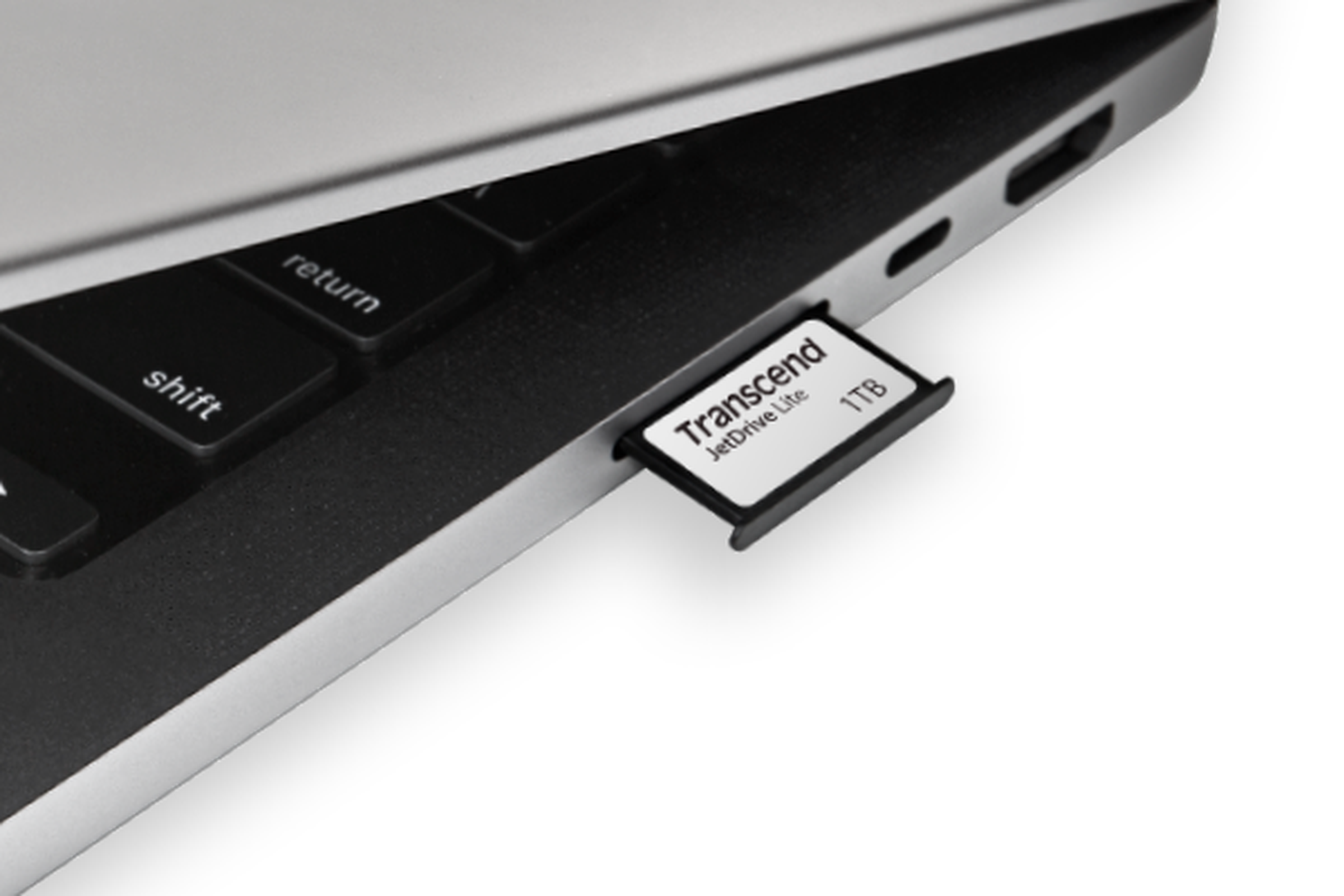 The JetDrive Lite 330 is partially inserted into the SD slot on a MacBook Pro.