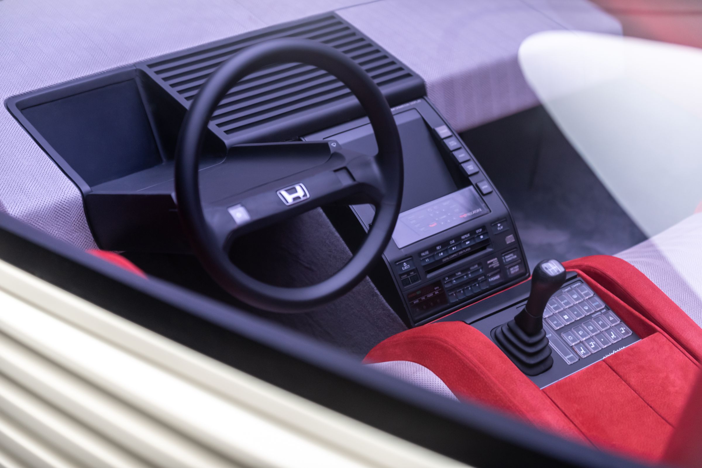 Picture of the interior of the HP-X, with a screen in the cnetrer console and in the dash in front of the driver.