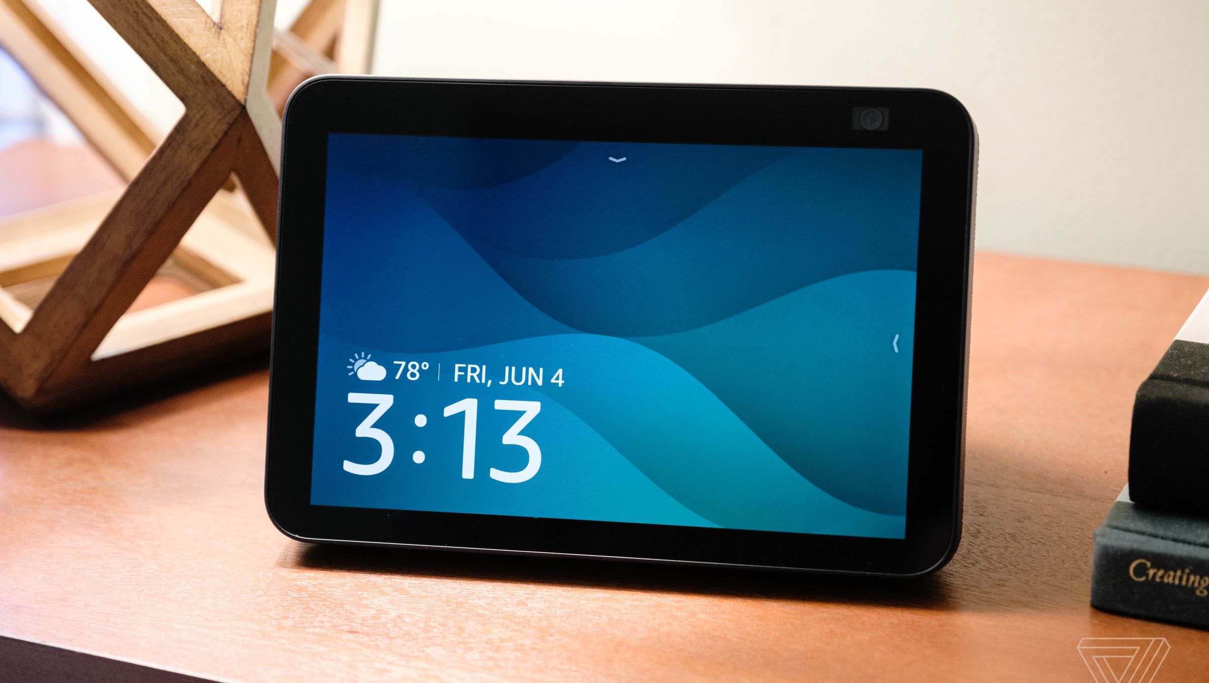 The second-generation Echo Show 8 with the main screen on display and resting on a table.