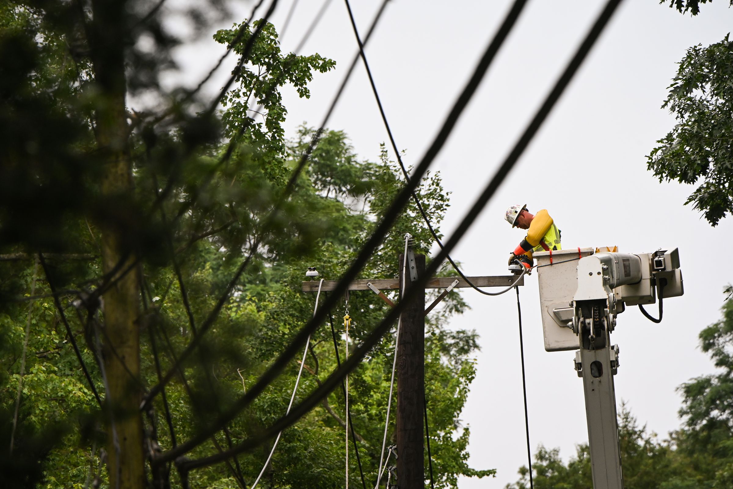 A Worker Fixes Downed Power Lines on Long Island Following Tropical Storm Isaias