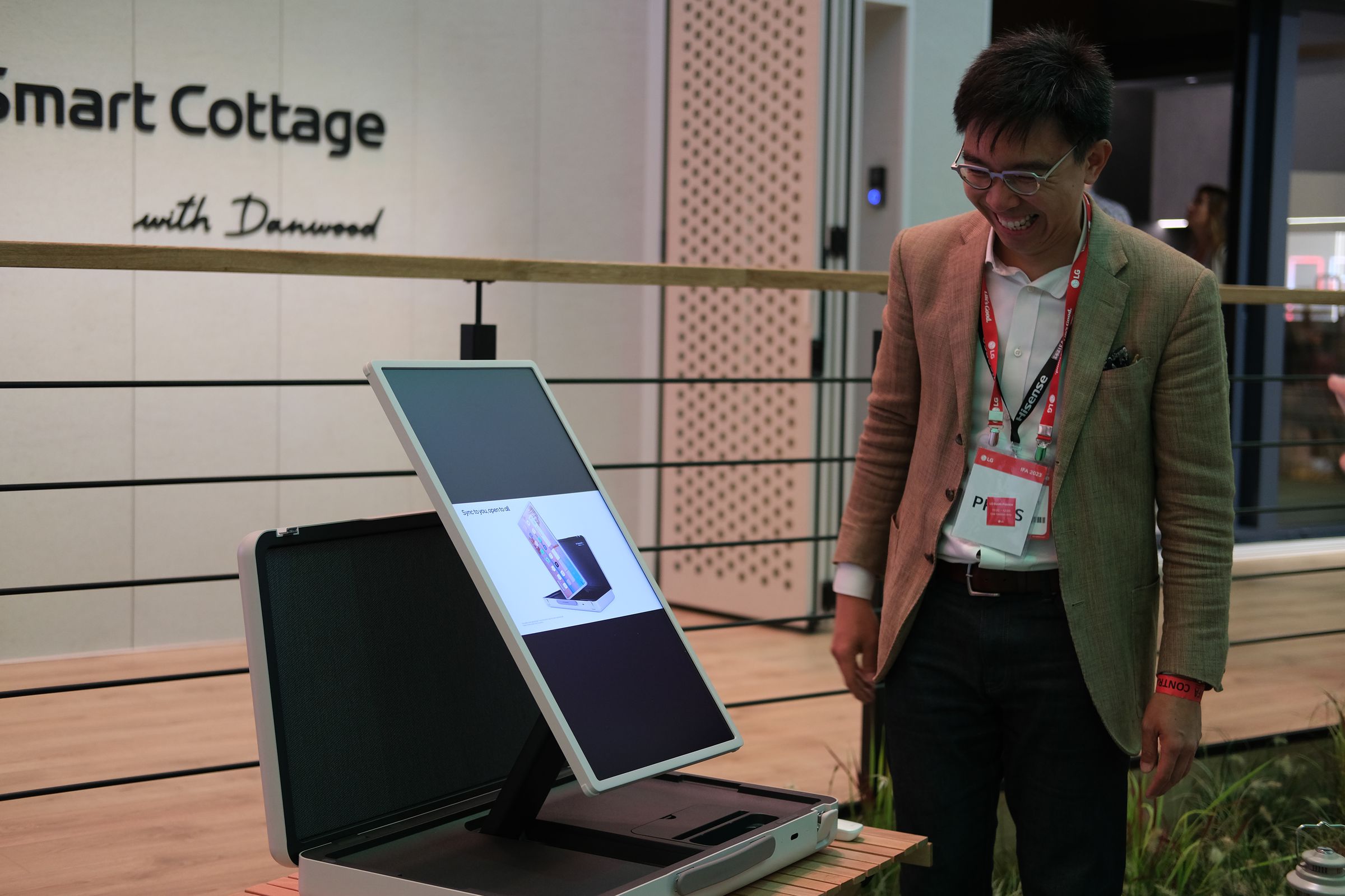 A TV journalist stands admiring the LG StanbyME Go.
