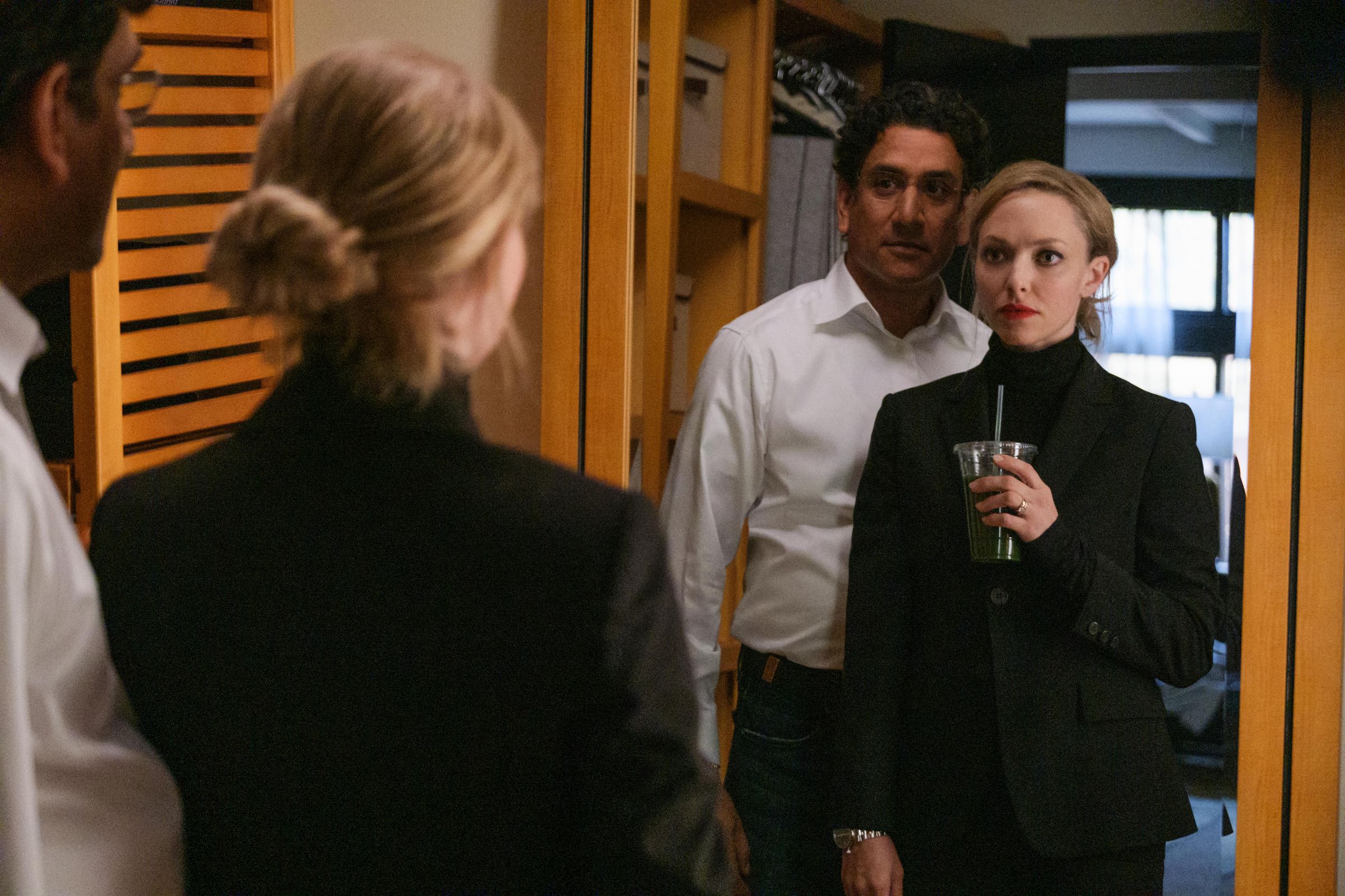Sunny Balwani and Elizabeth Holmes staring at their reflections in a mirror together.