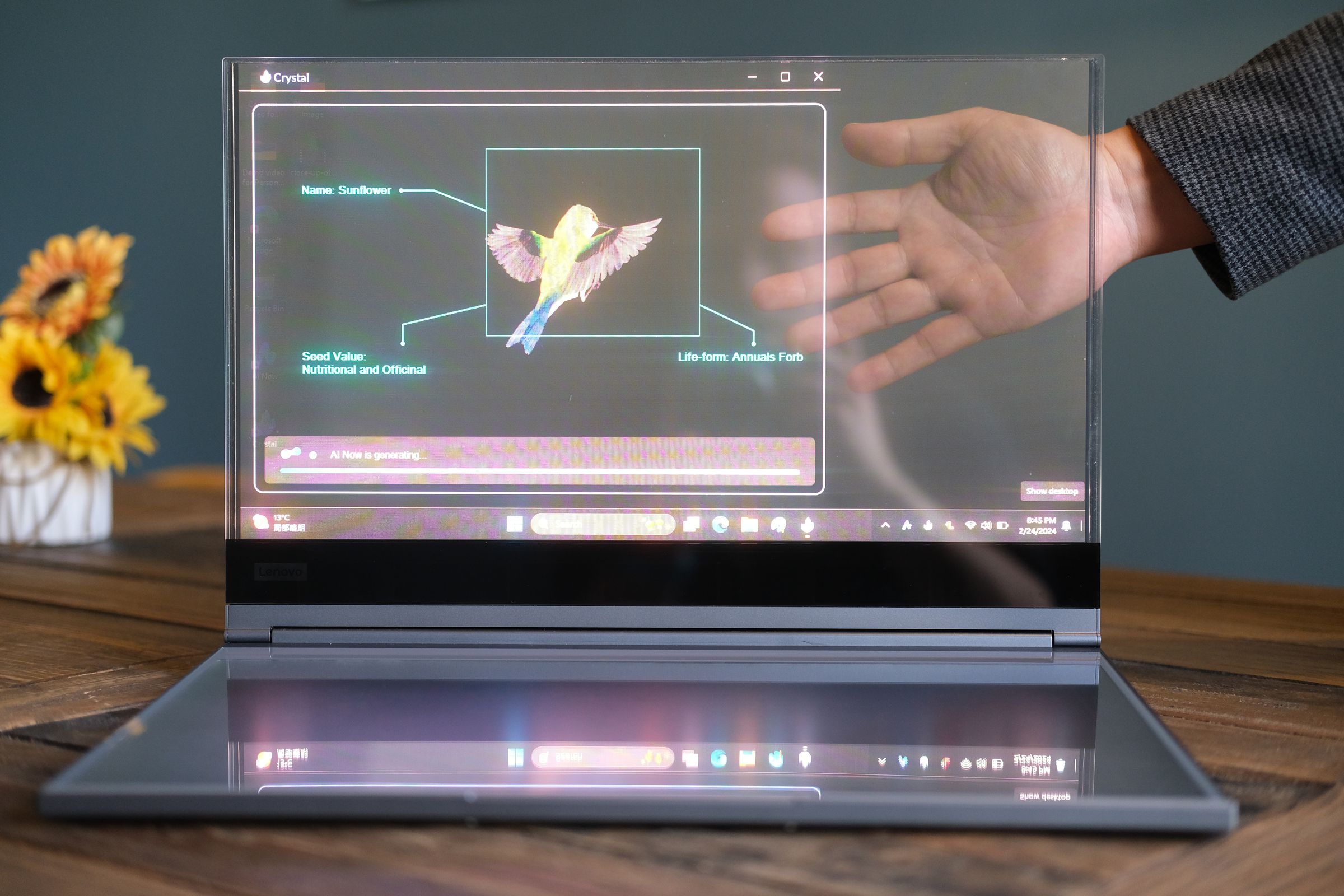 Lenovo’s ThinkBook Transparent Display Laptop with a hand visible behind the display.