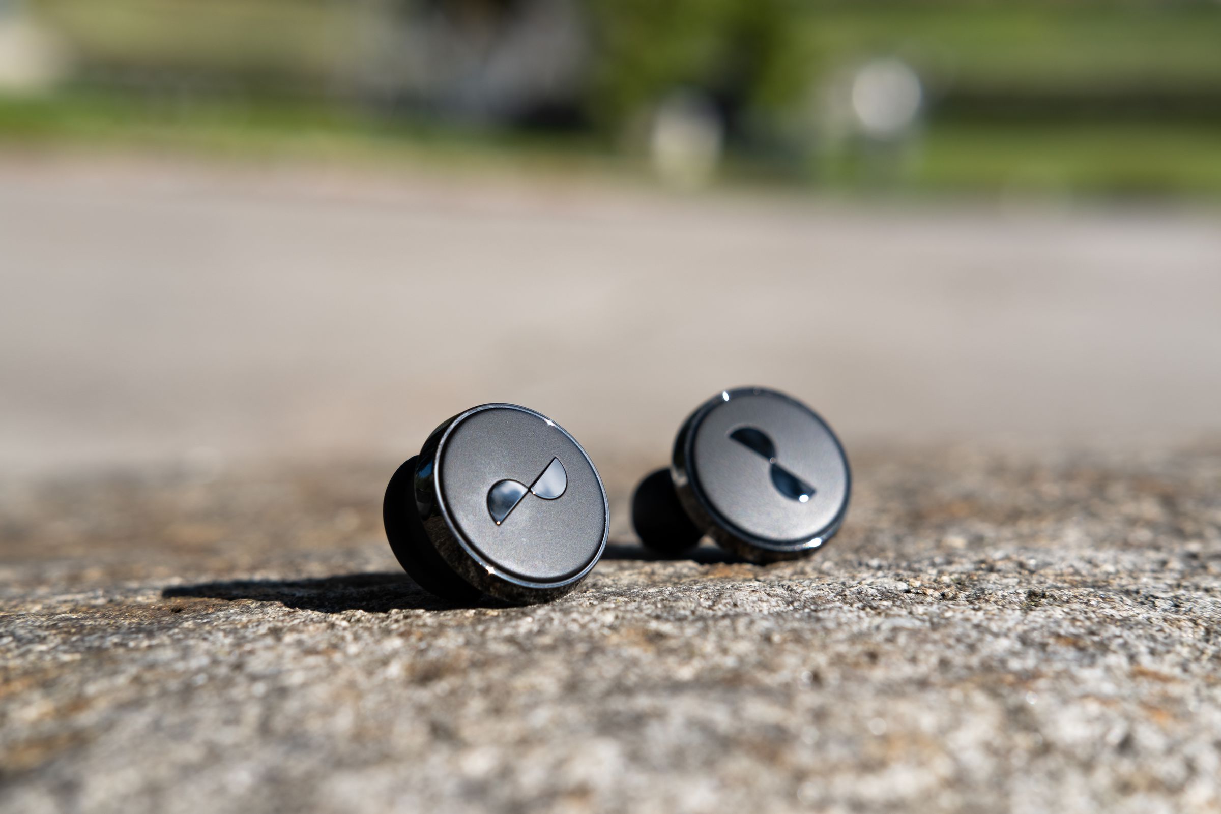 The NuraTrue Pro earbuds, outside of their case.
