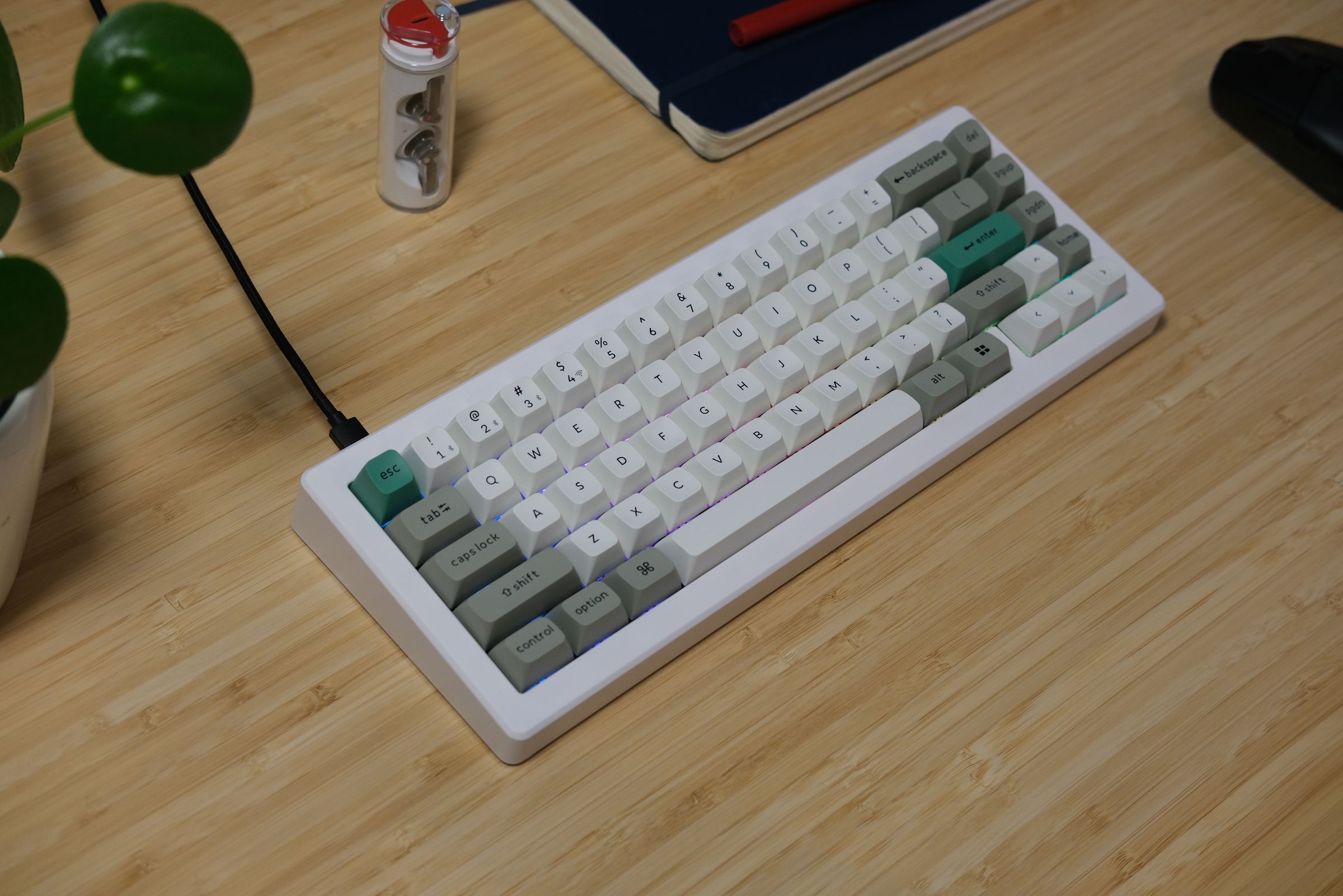 CSTM65 with white, gray, and green keycaps and a white case.