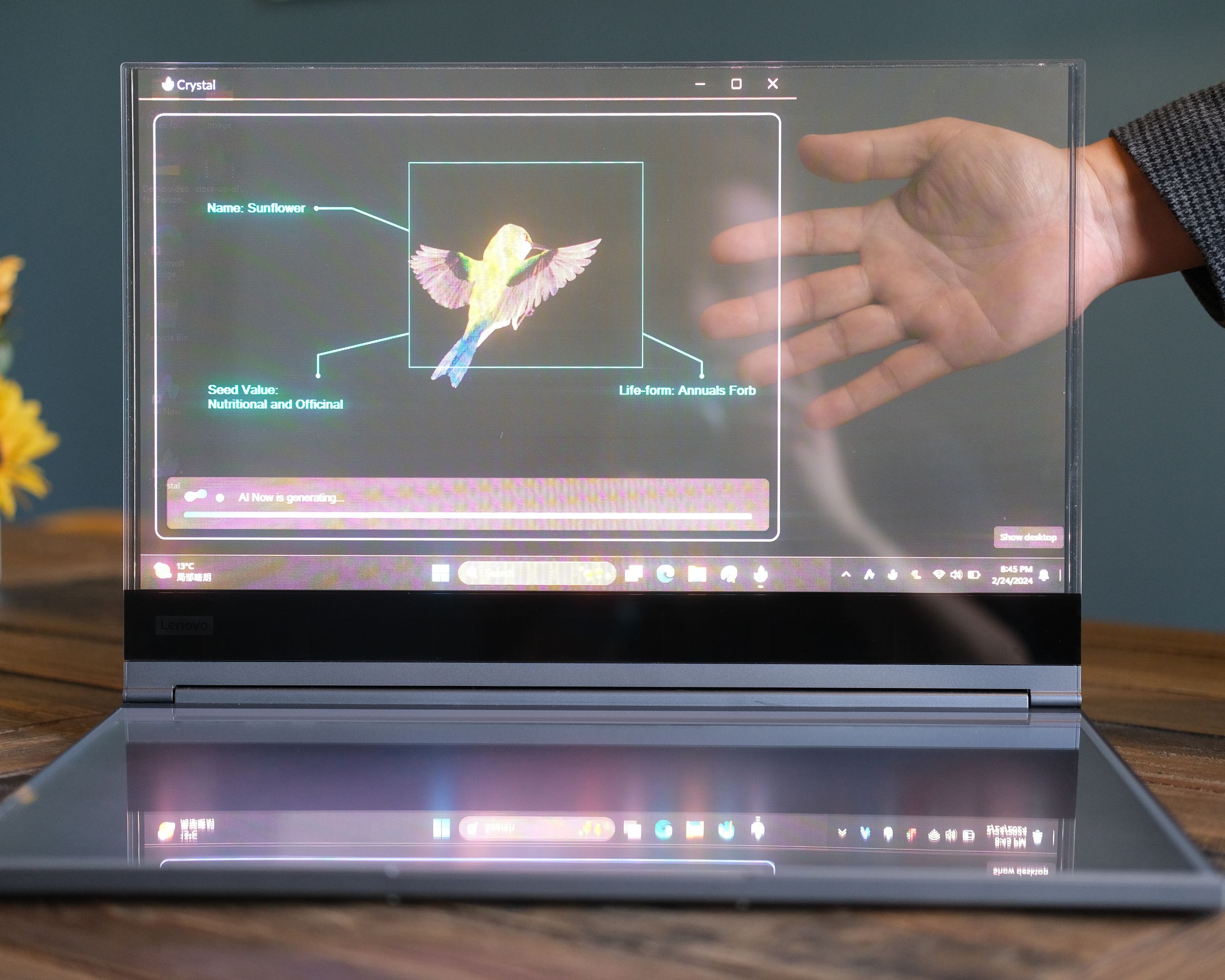 Lenovo’s ThinkBook Transparent Display Laptop with a hand visible behind the display.