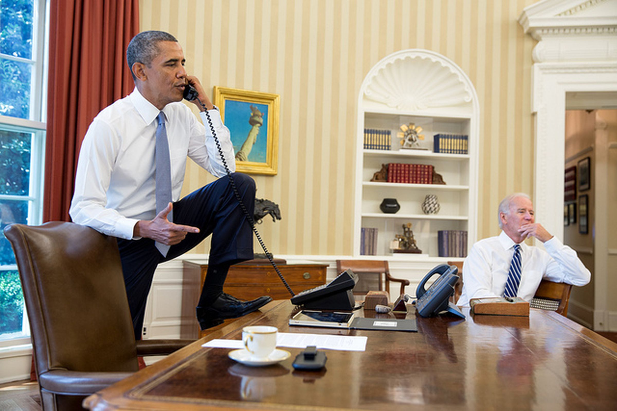 Obama stepping on desk (White House DSouza)