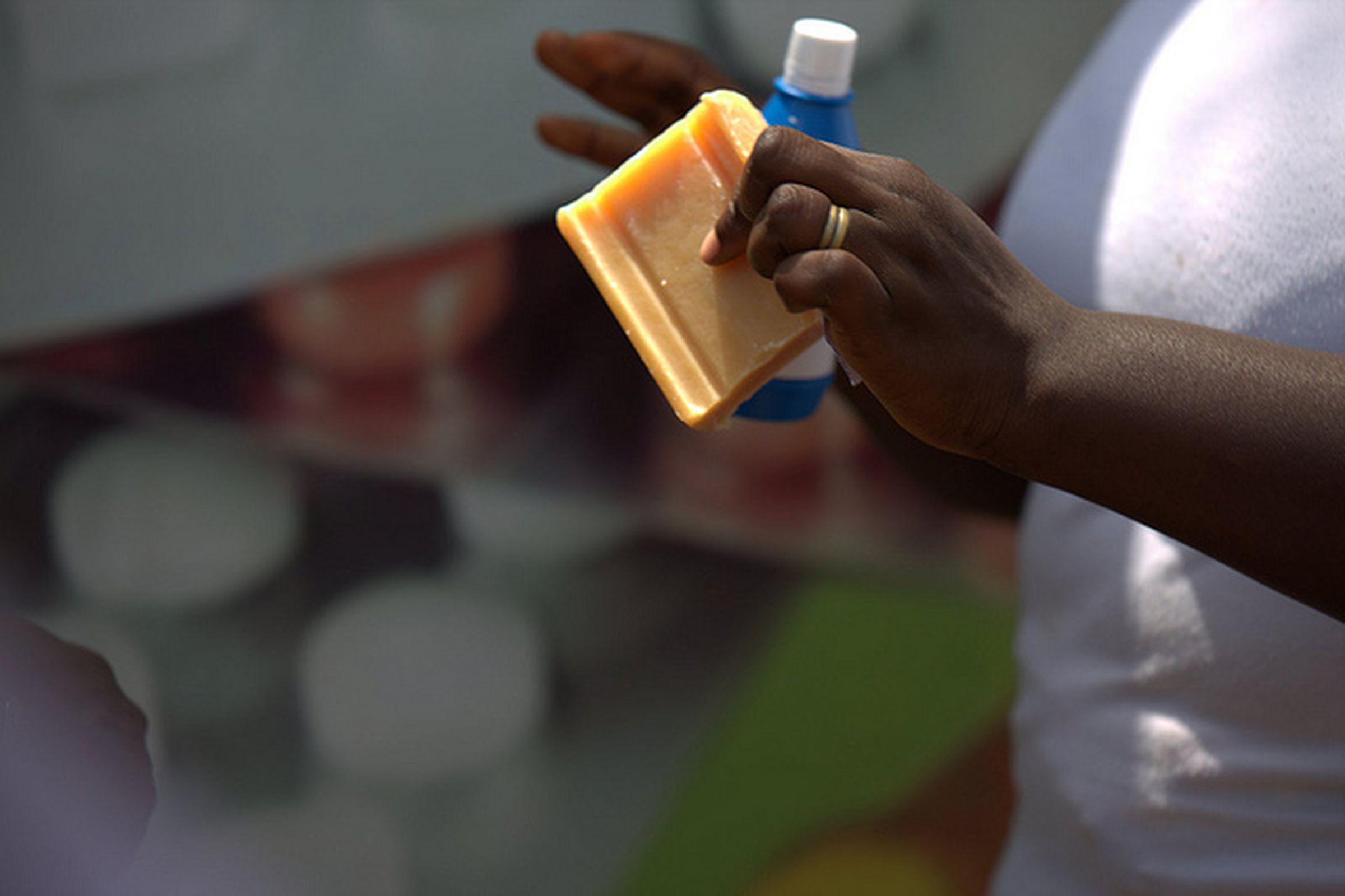 A UNICEF worker in Conakry, Guinea distributing soap and chlorine and teaching residents how to combat ebola.