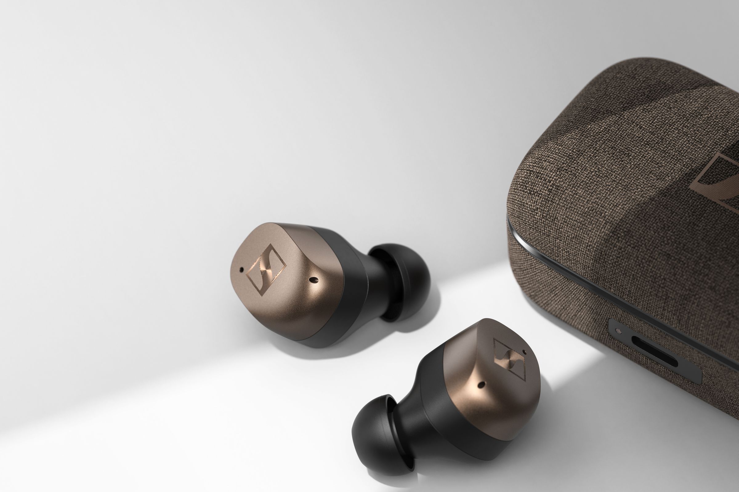 Sennheiser’s Momentum True Wireless 4 earbuds next to their charging case.