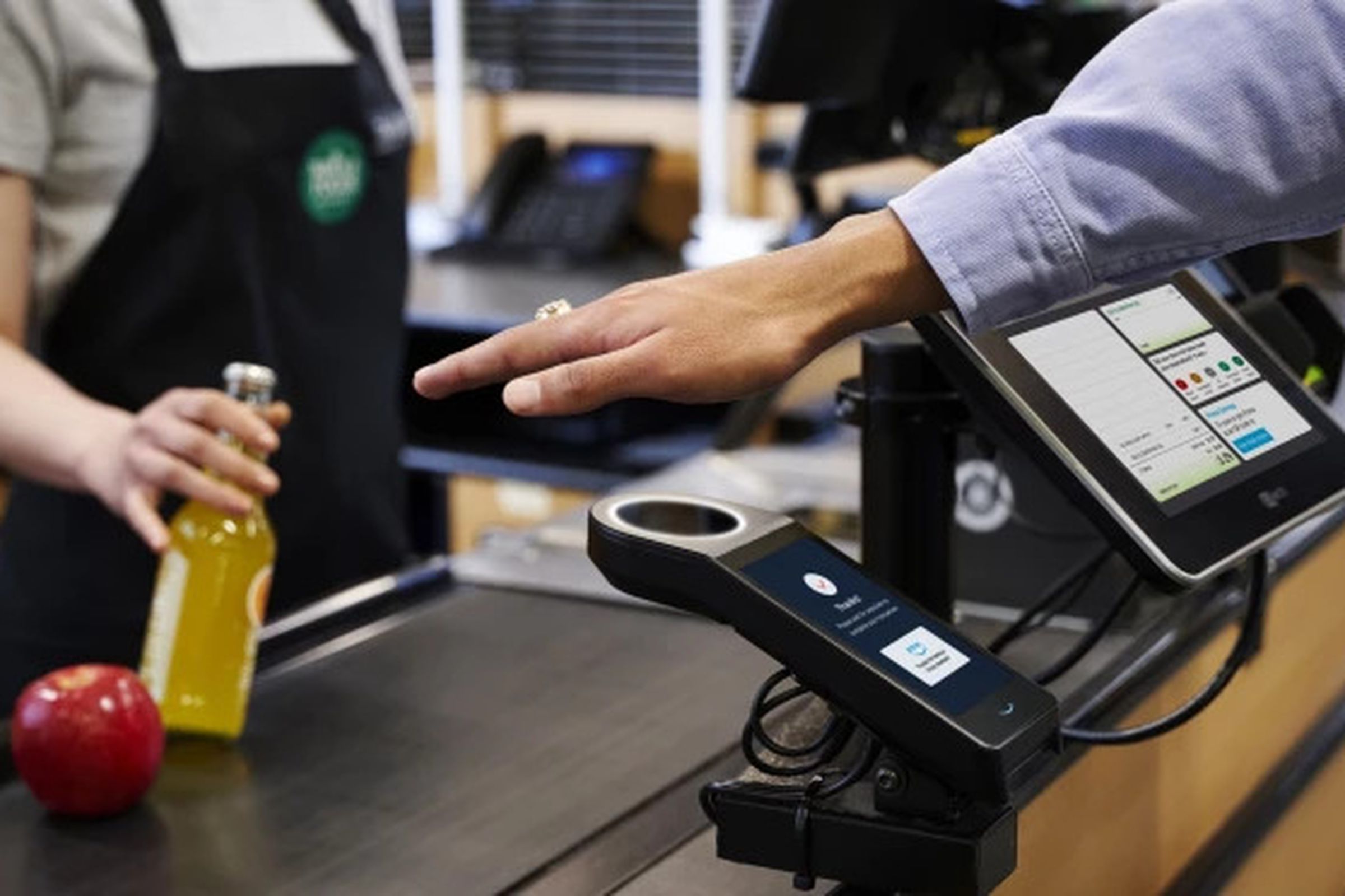 An image showing someone hovering their palm over Amazon’s scanner