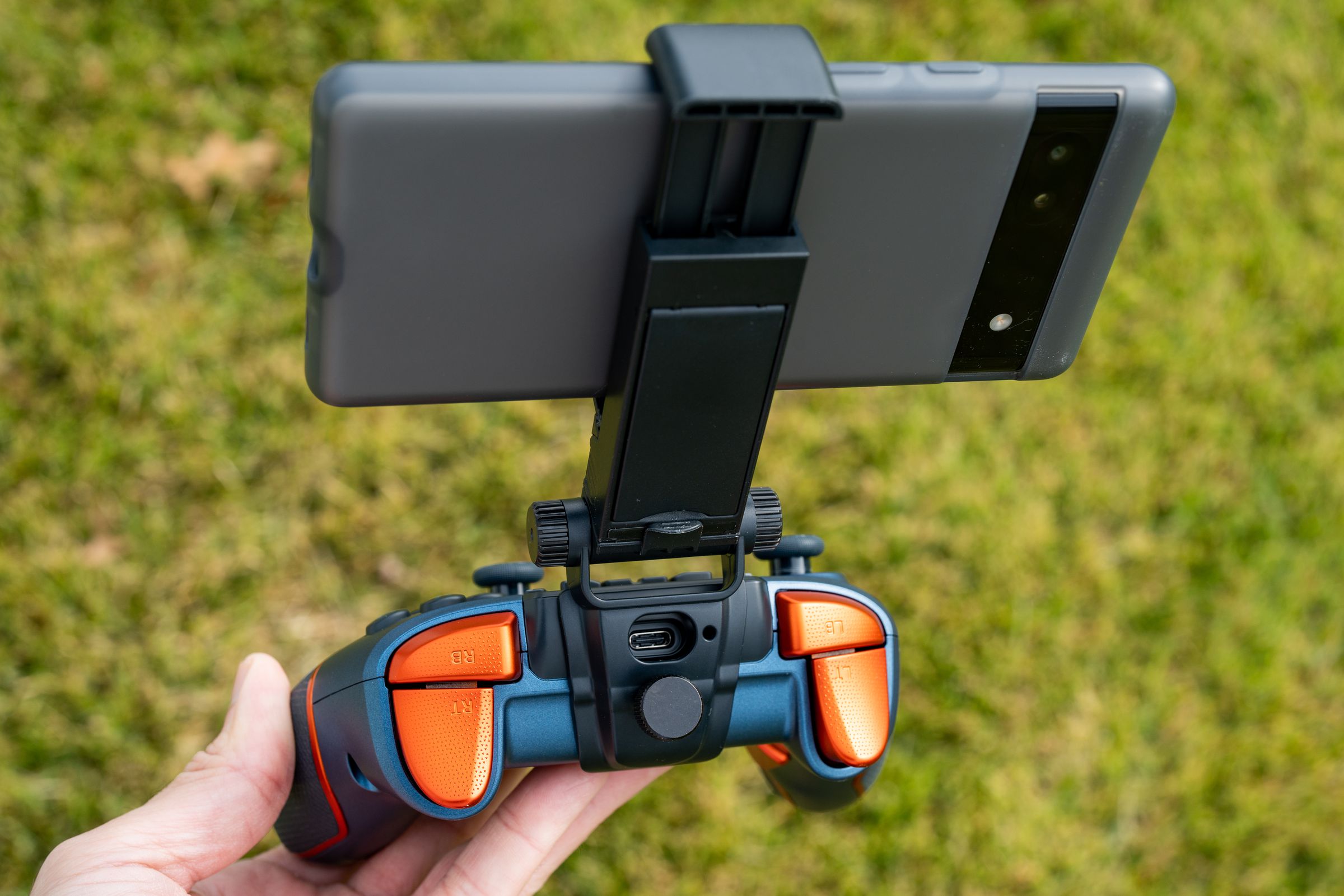 The mount allows access to the USB-C port. While the screws to adjust the angle are plastic, they feel fine.