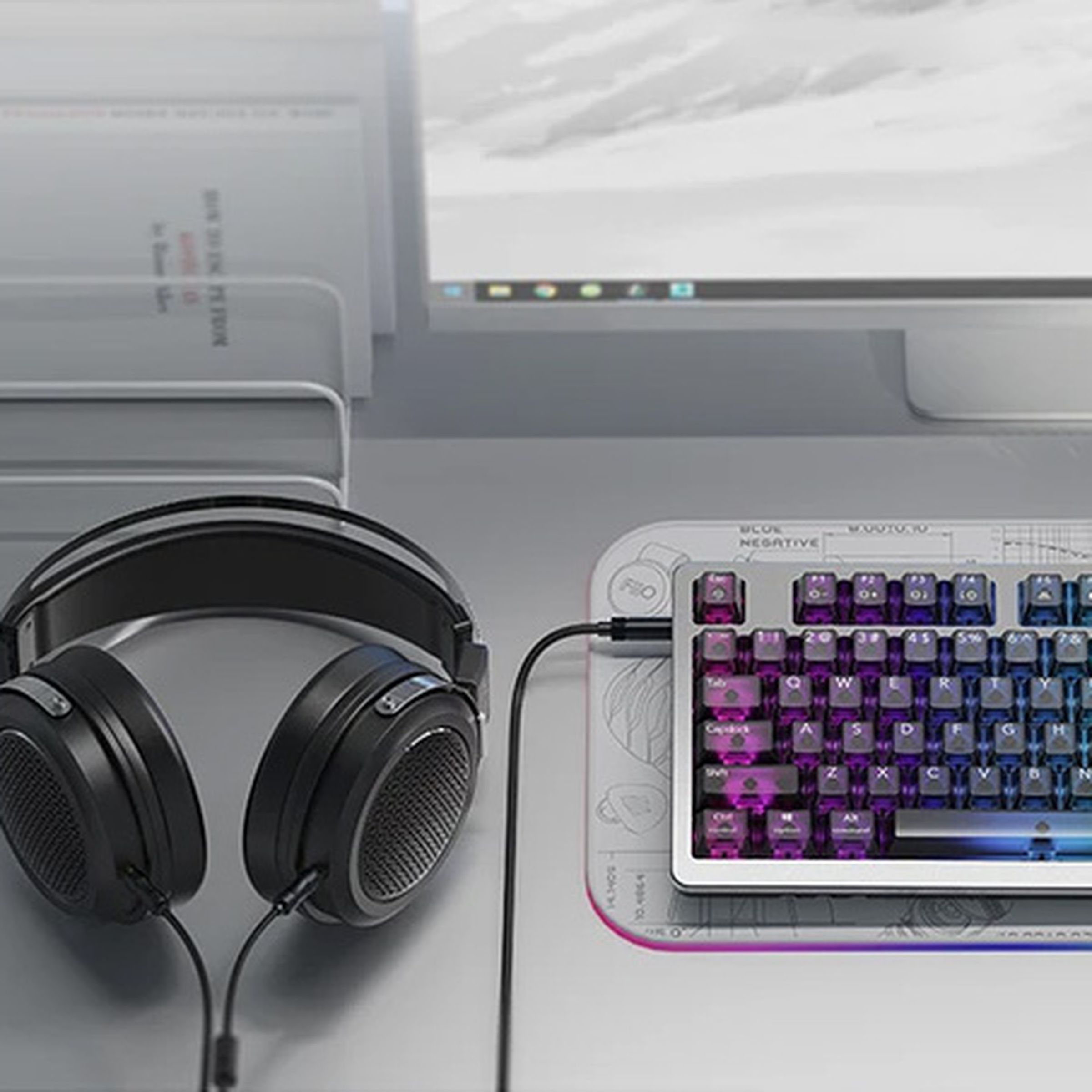 Headphones plugged into keyboard on desk.