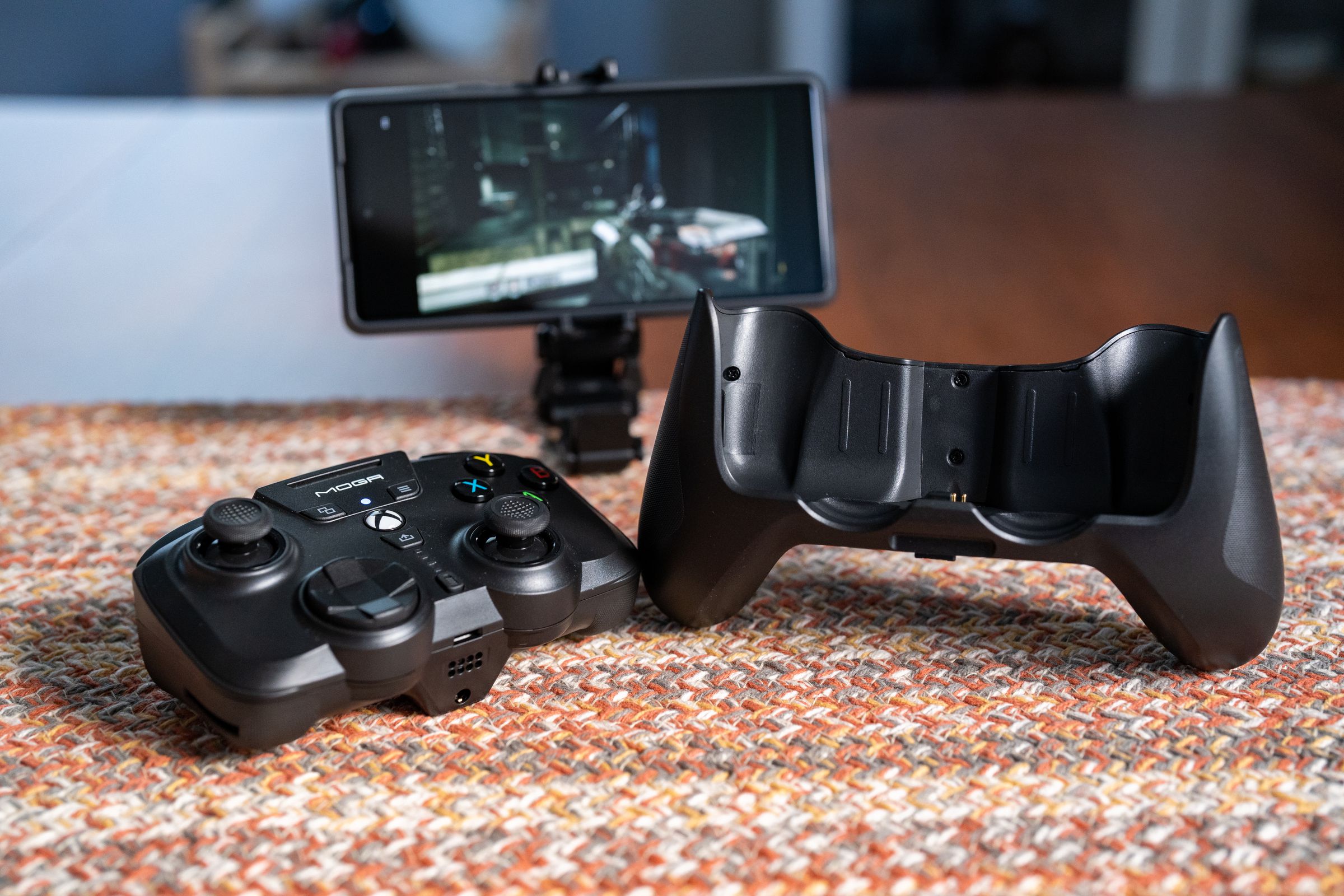 The MOGA XP-Ultra mini-pad, phone clip (with an attached Pixel 6A), and its full-size hand grip — or, as I like to call it, the pants.