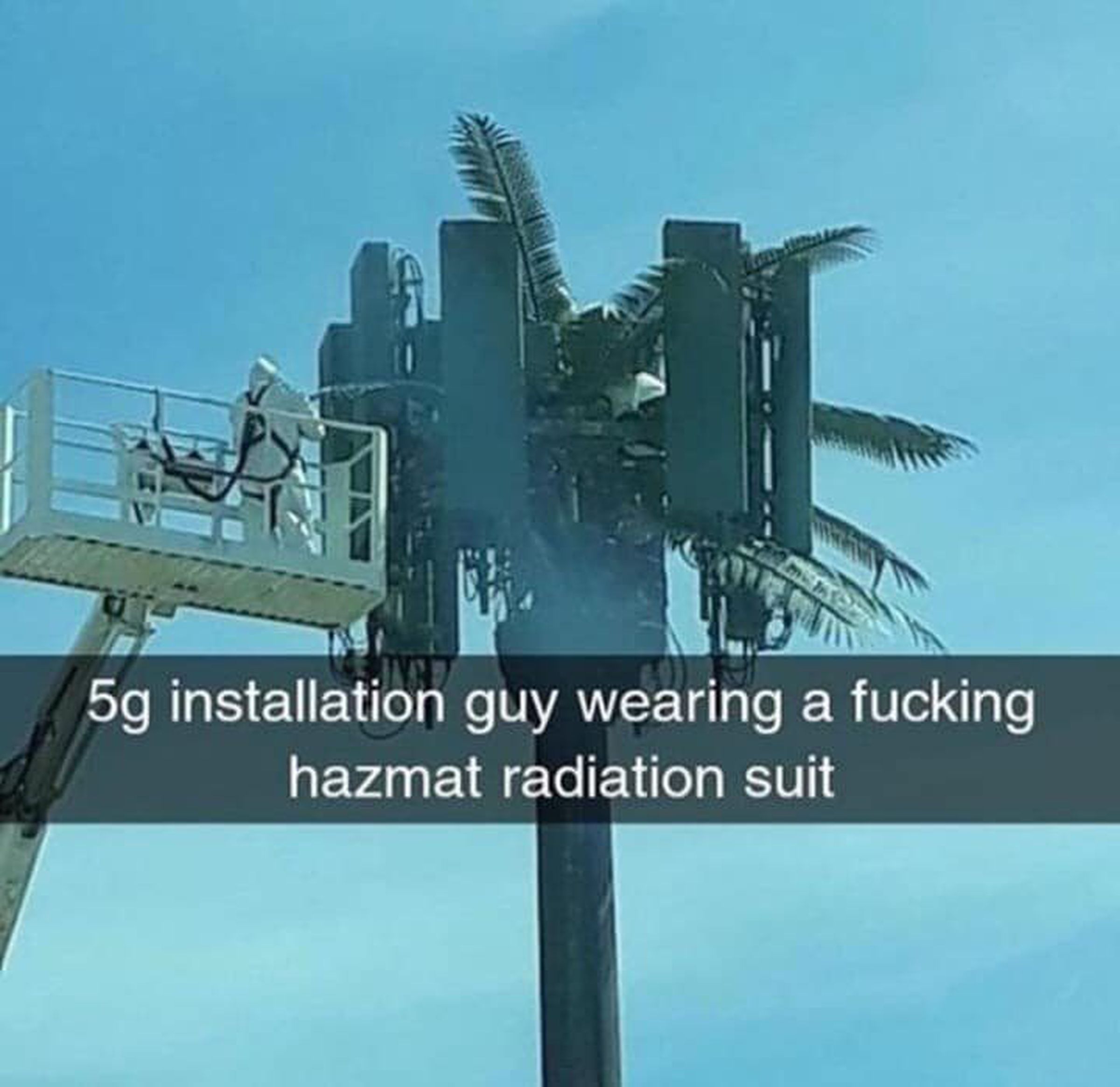 A viral image that supposedly shows a man in a hazmat suit cleaning a 5G mast.