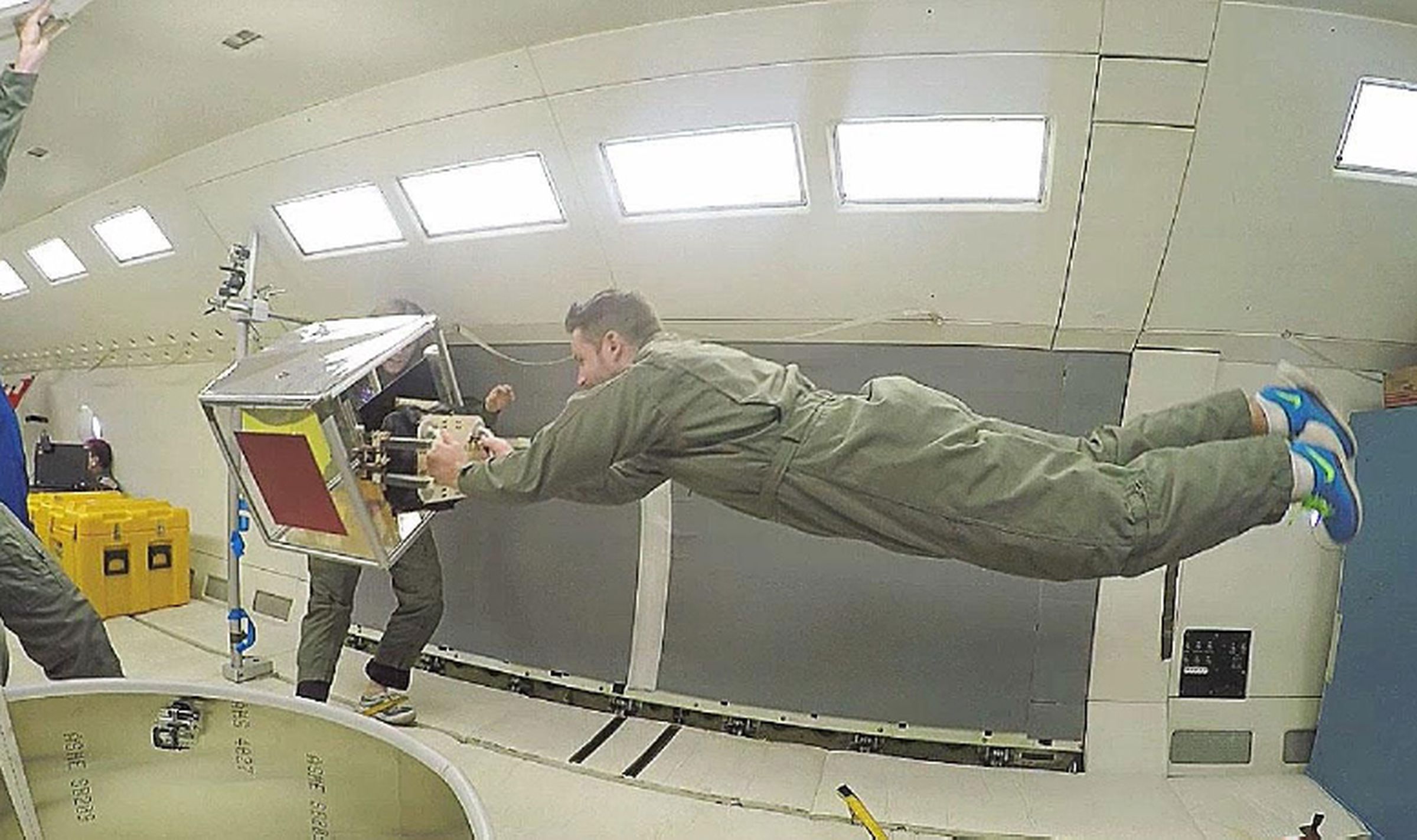 The robotic gripper grabbing a cube on a parabolic flight.
