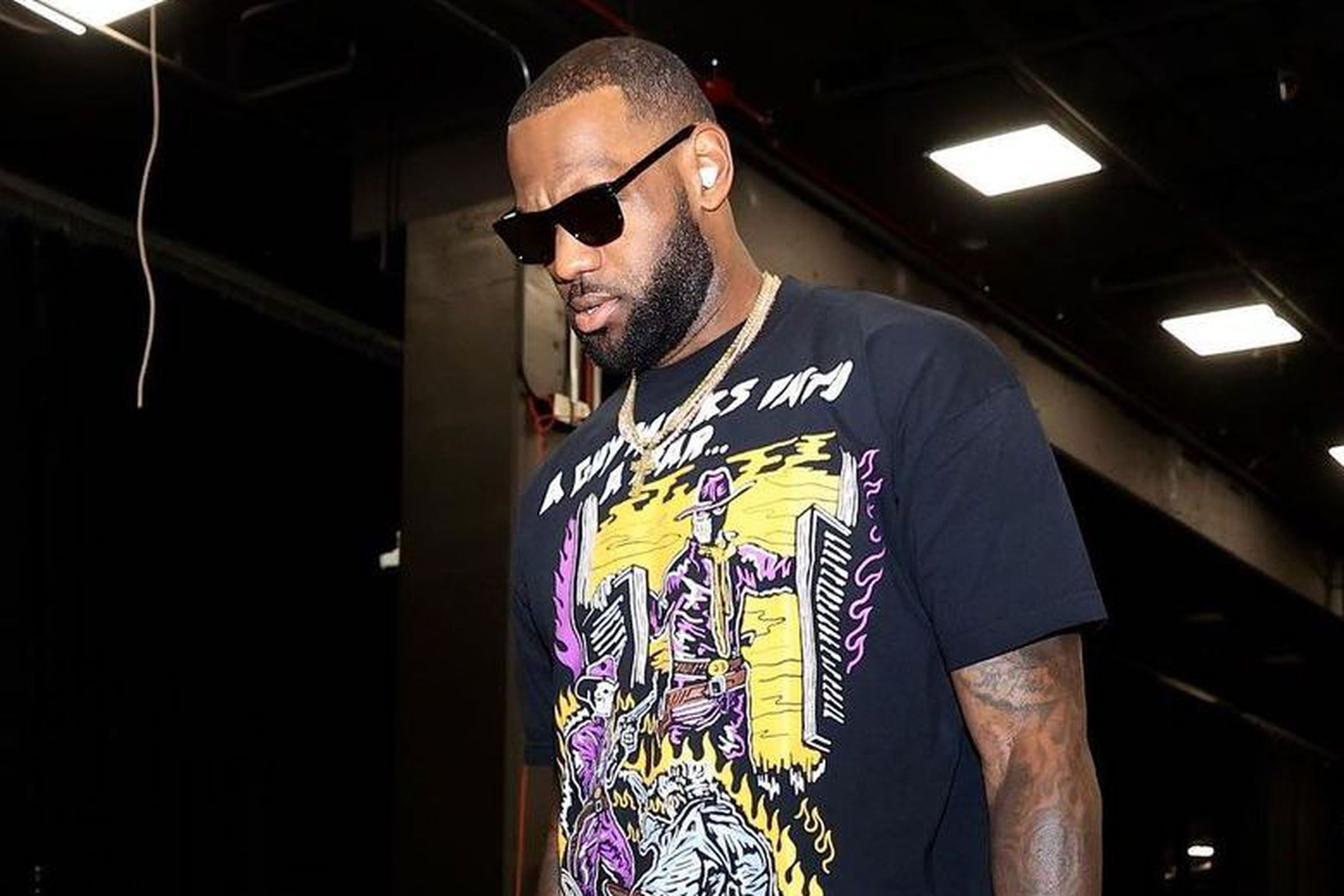 LeBron James wearing what appear to be Beats Studio Buds.