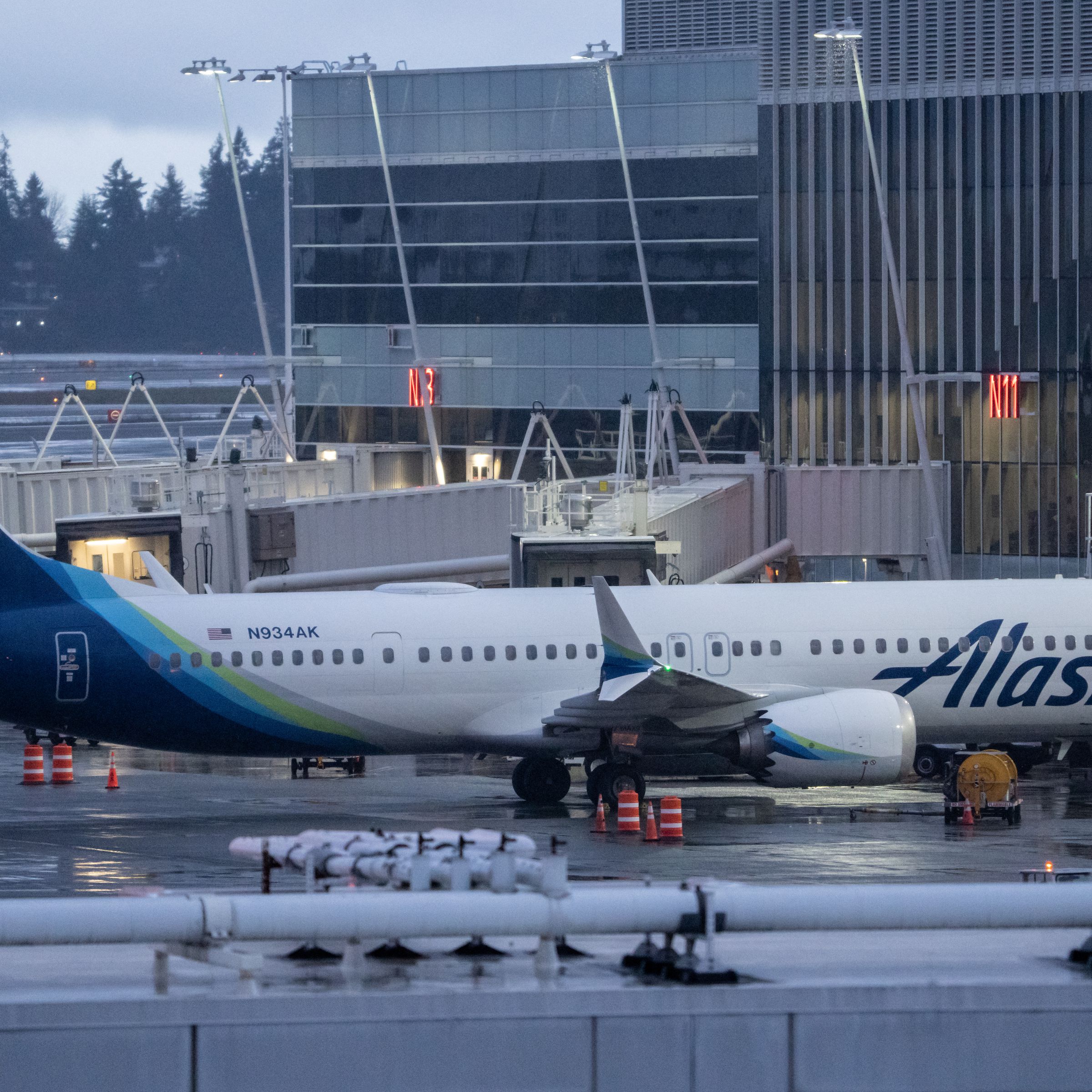 A picture of a Boeing 737 Max 9 plane sitting at a gate at an airport in Seattle.