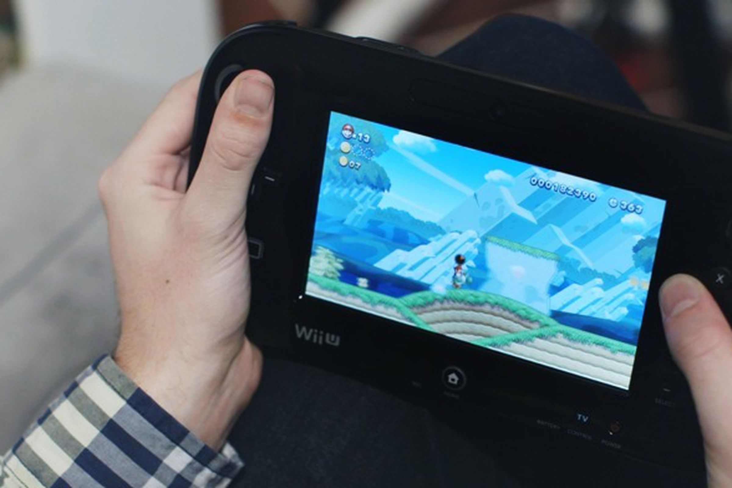 A photo showing someone playing the Wii U
