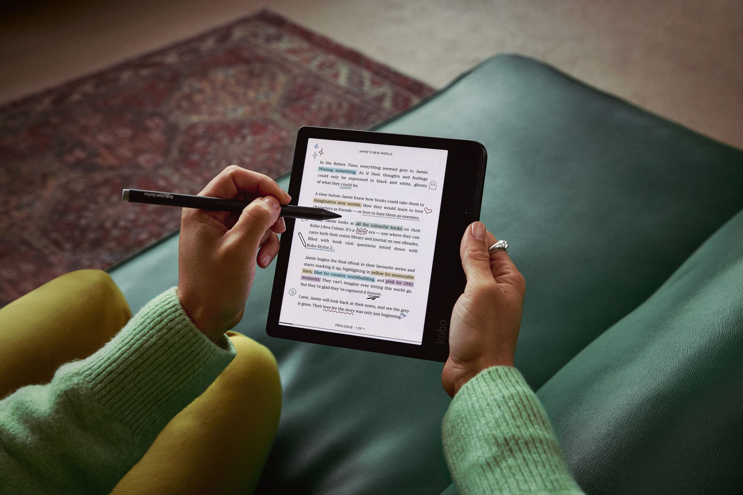 A hand using a stylus to take notes on the Kobo Libra Colour e-reader.