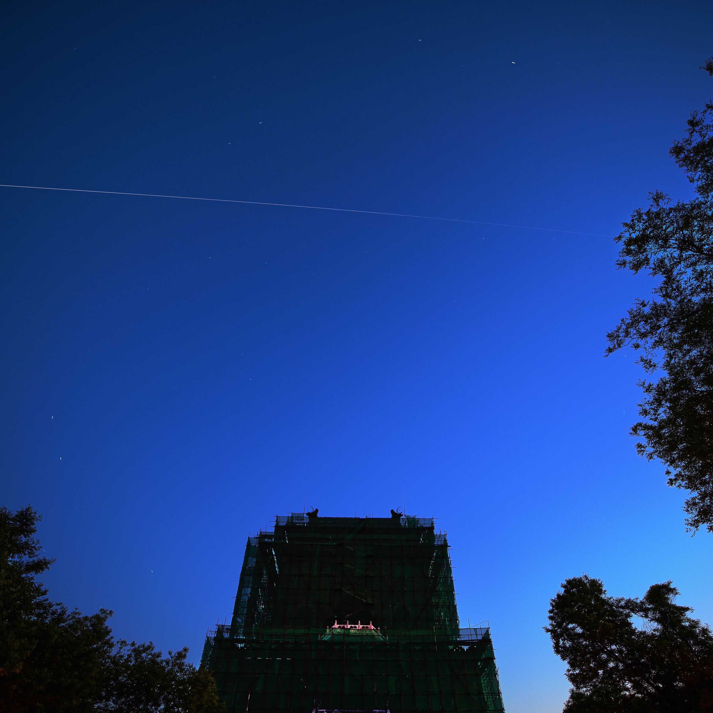 China’s space station core module ‘Tianhe’ flies over the Bell Tower on May 2, 2021 in Beijing, China.