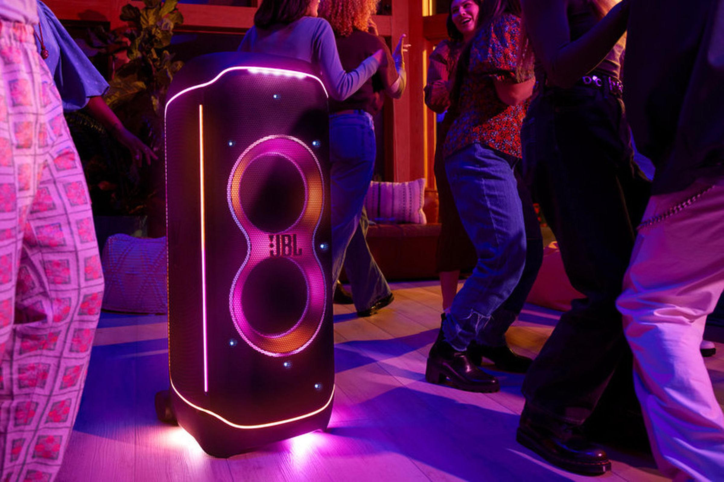 A JBL PartyBox Ultimate illuminated with RGB lighting.