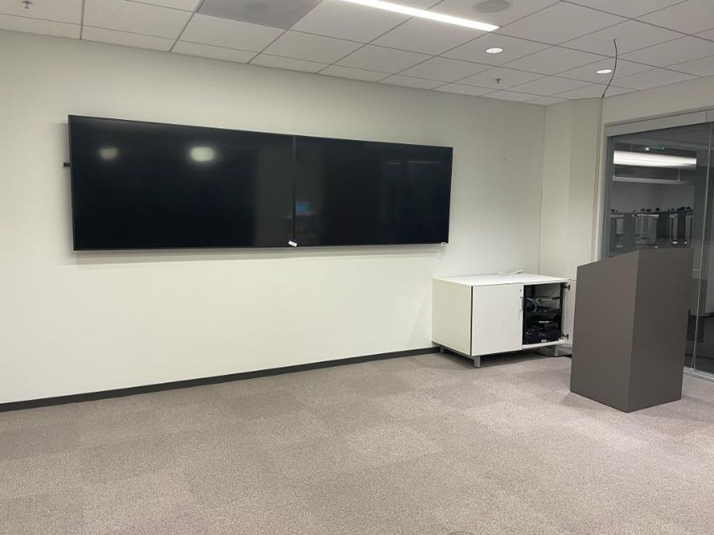 Two 75-inch wall-mounted Samsung displays