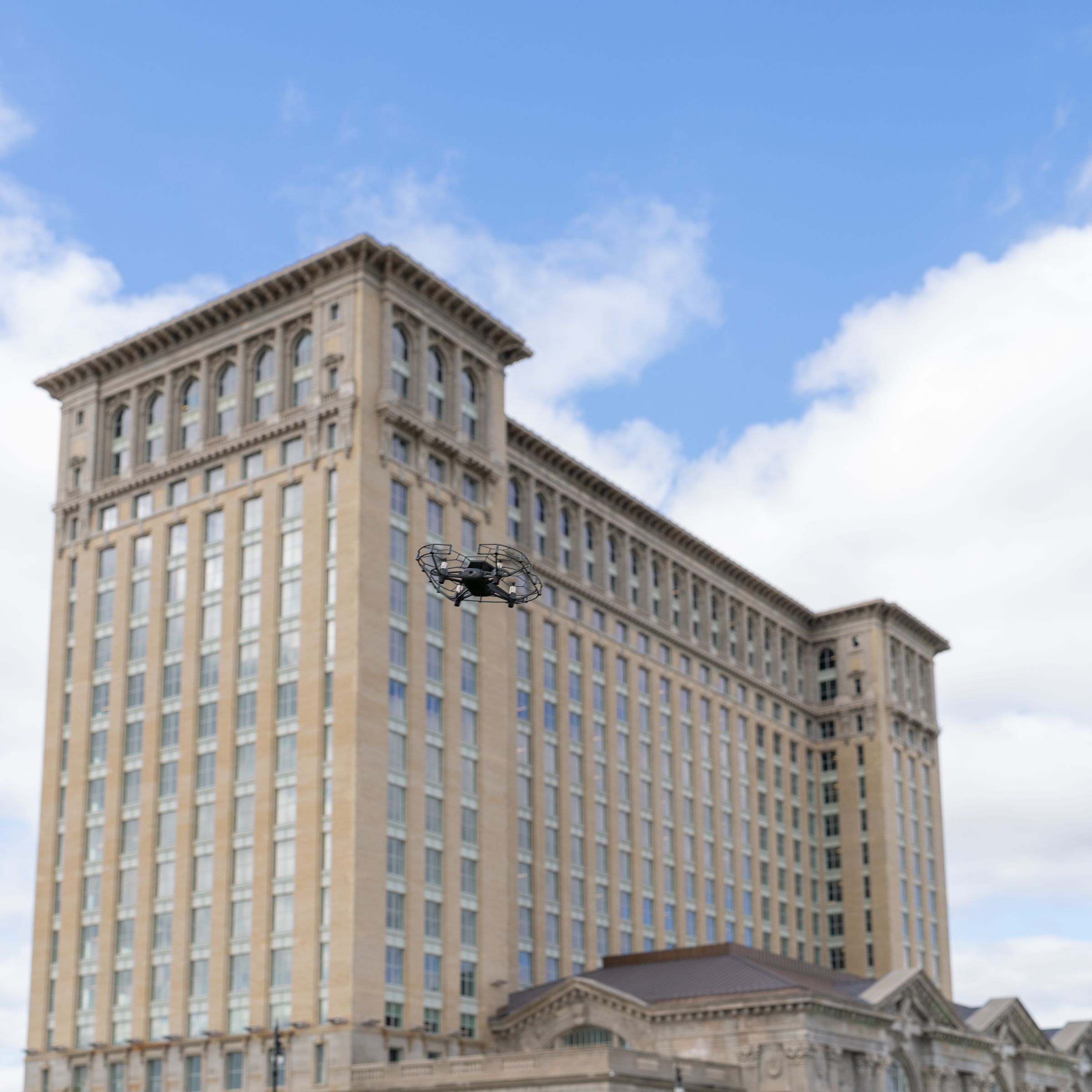 A drone flying next to Michigan Central train station in Detroit