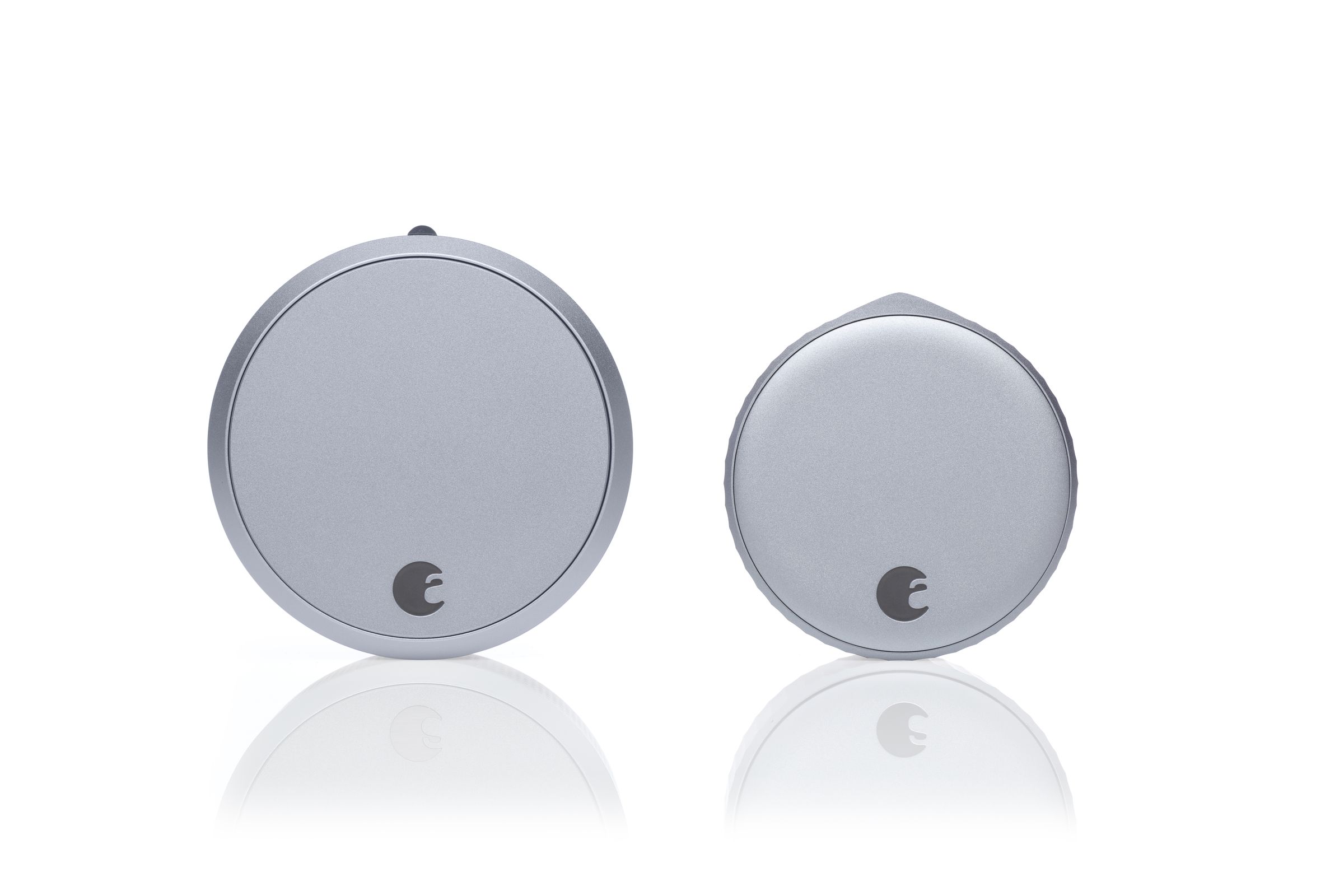 An August Smart Lock Pro next to an August Wi-Fi Smart Lock on a white background