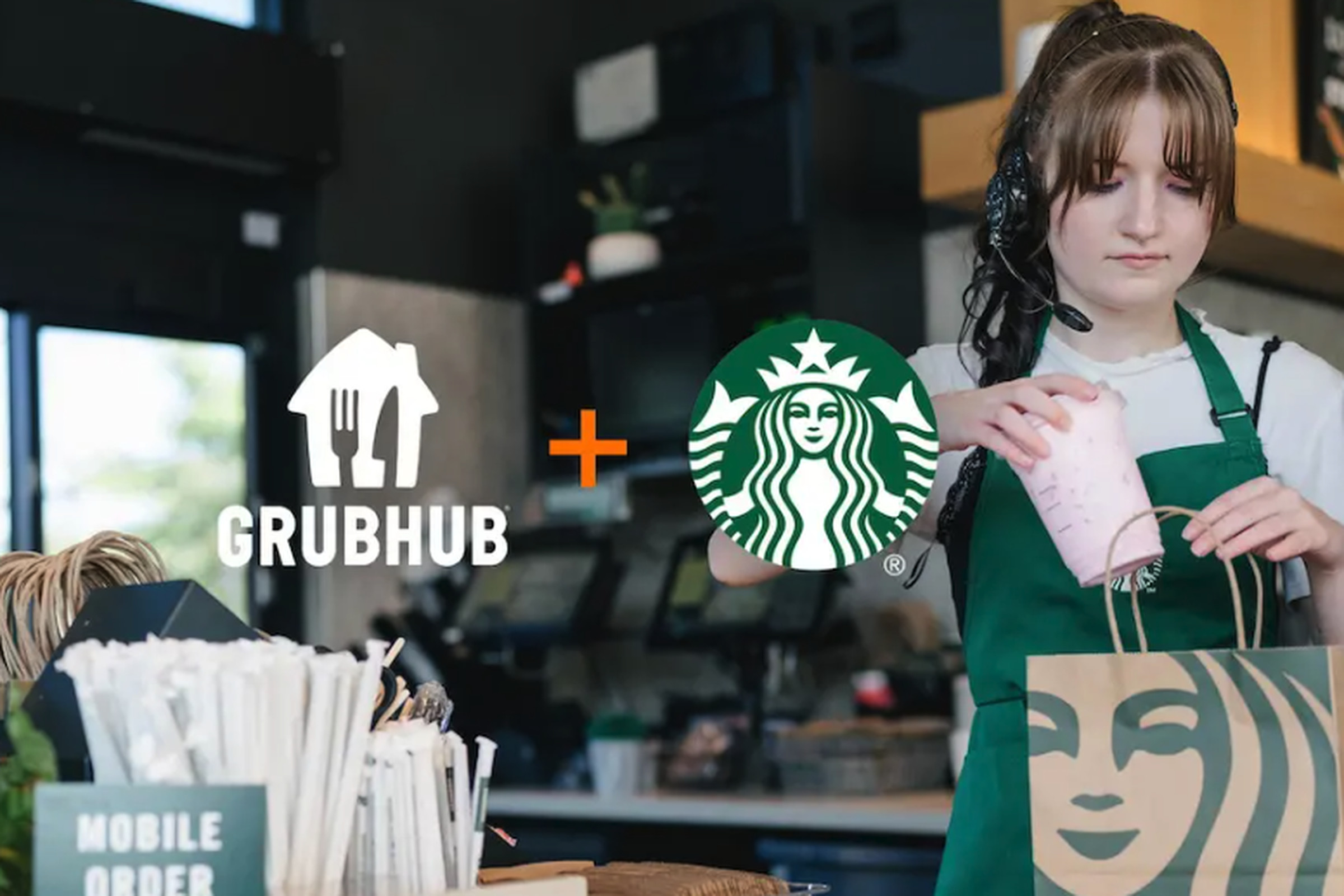 Starbucks barista to the right making a beverage with Grubhub and Starbucks logos in the middle. 