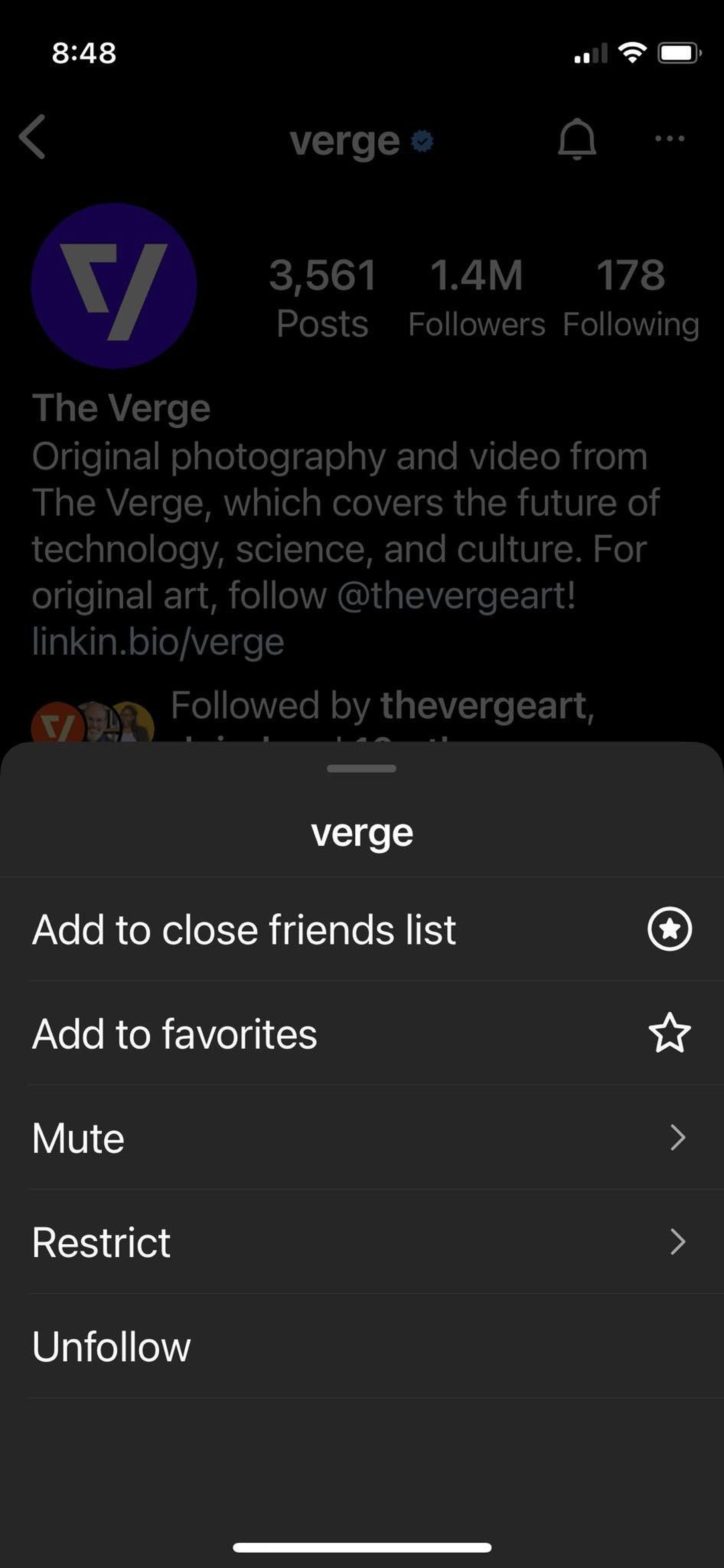 Phone screen with pop-up menu at bottom offering options to mute, restrict or unfollow.