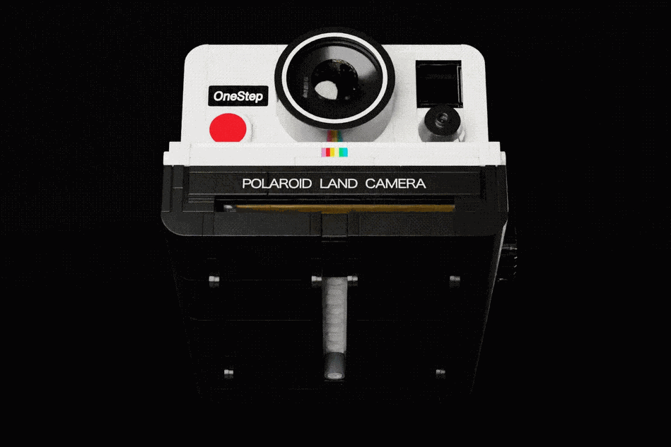 GIF of the Lego Polaroid replica with a “picture” being slotted in and out of the film flap.