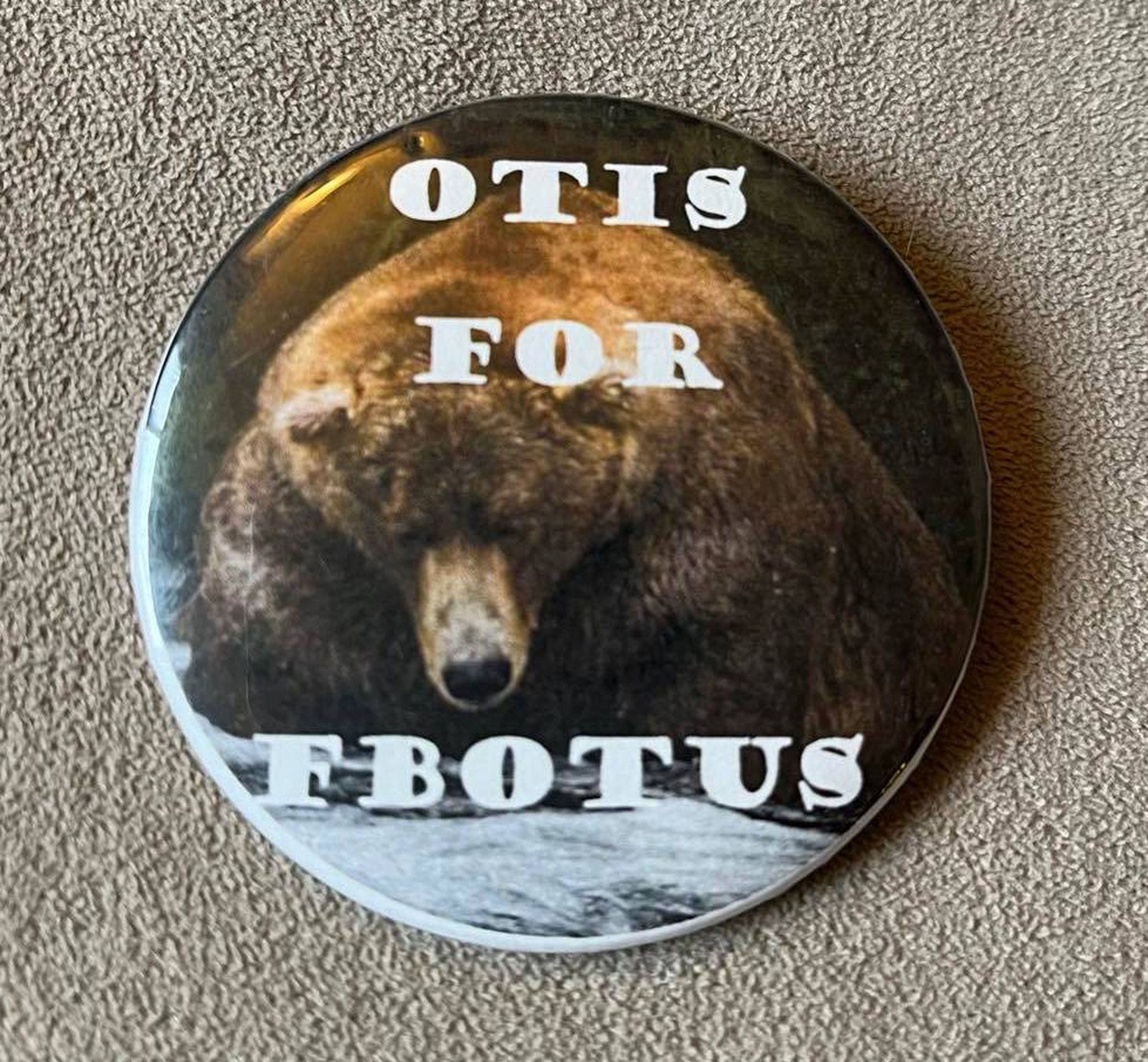 A button with a photo of a large brown bear, Otis, that reads “OTIS FOR FBOTUS.”