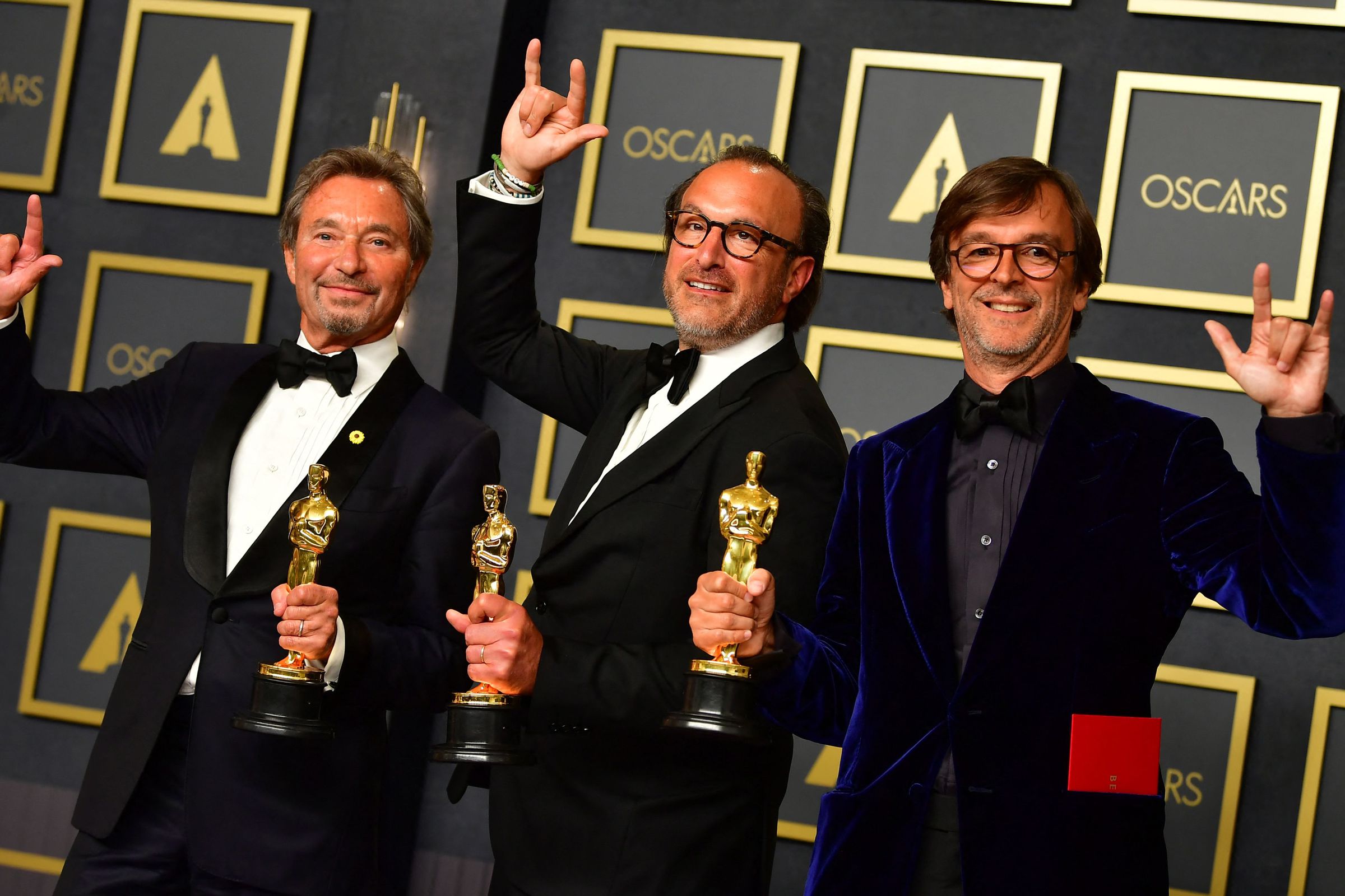 Coda producers Philippe Rousselet (L), Fabrice Gianfermi (R) and Patrick Wachsberger (C) posing with Code’s Best Picture award.