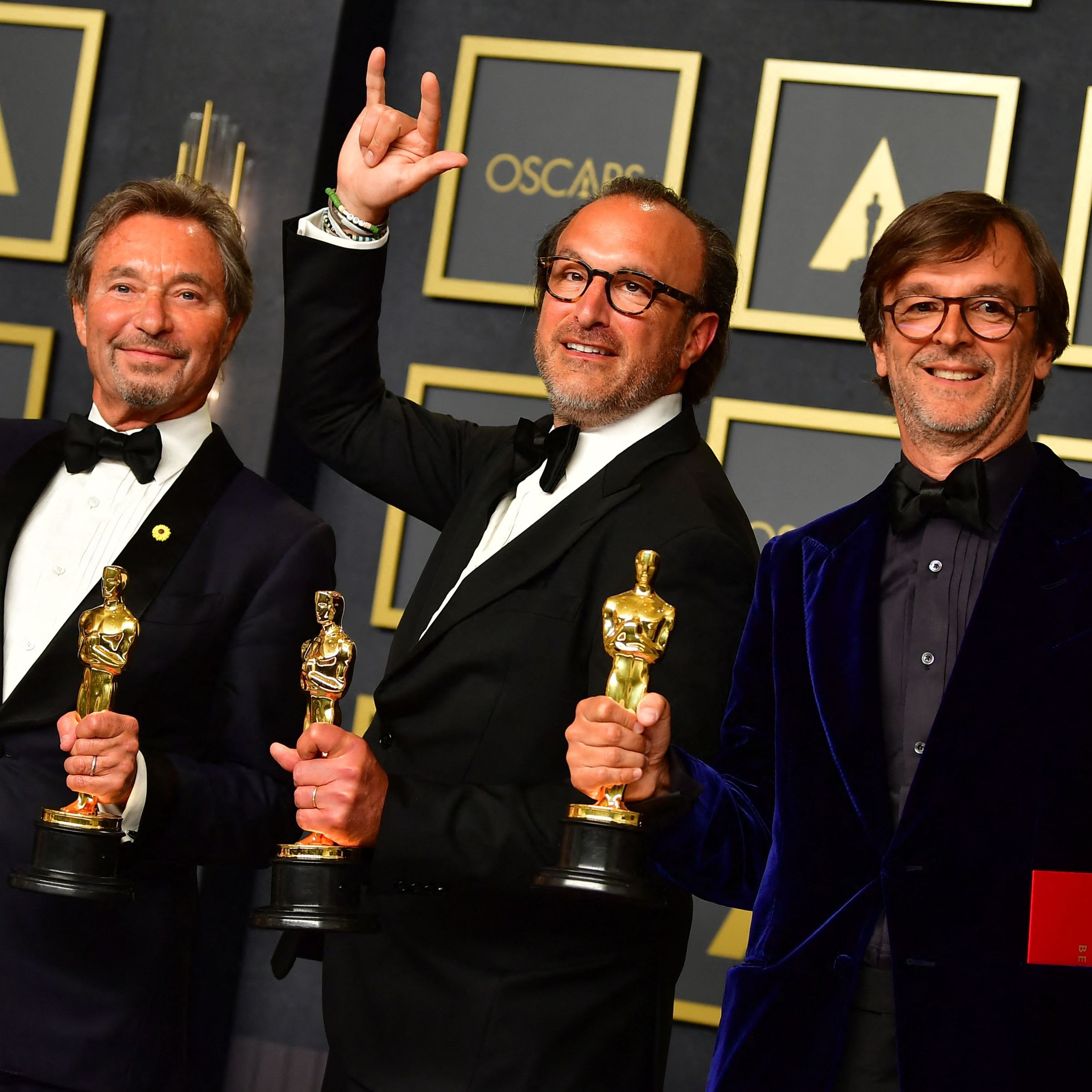 Coda producers Philippe Rousselet (L), Fabrice Gianfermi (R) and Patrick Wachsberger (C) posing with Code’s Best Picture award.