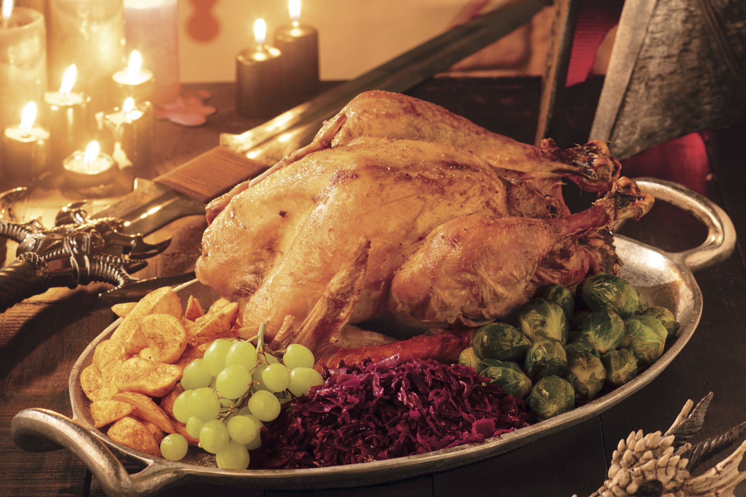 A roast turkey dinner in front of a helmet, sword, and banner representing Dragon Age’s templar order.