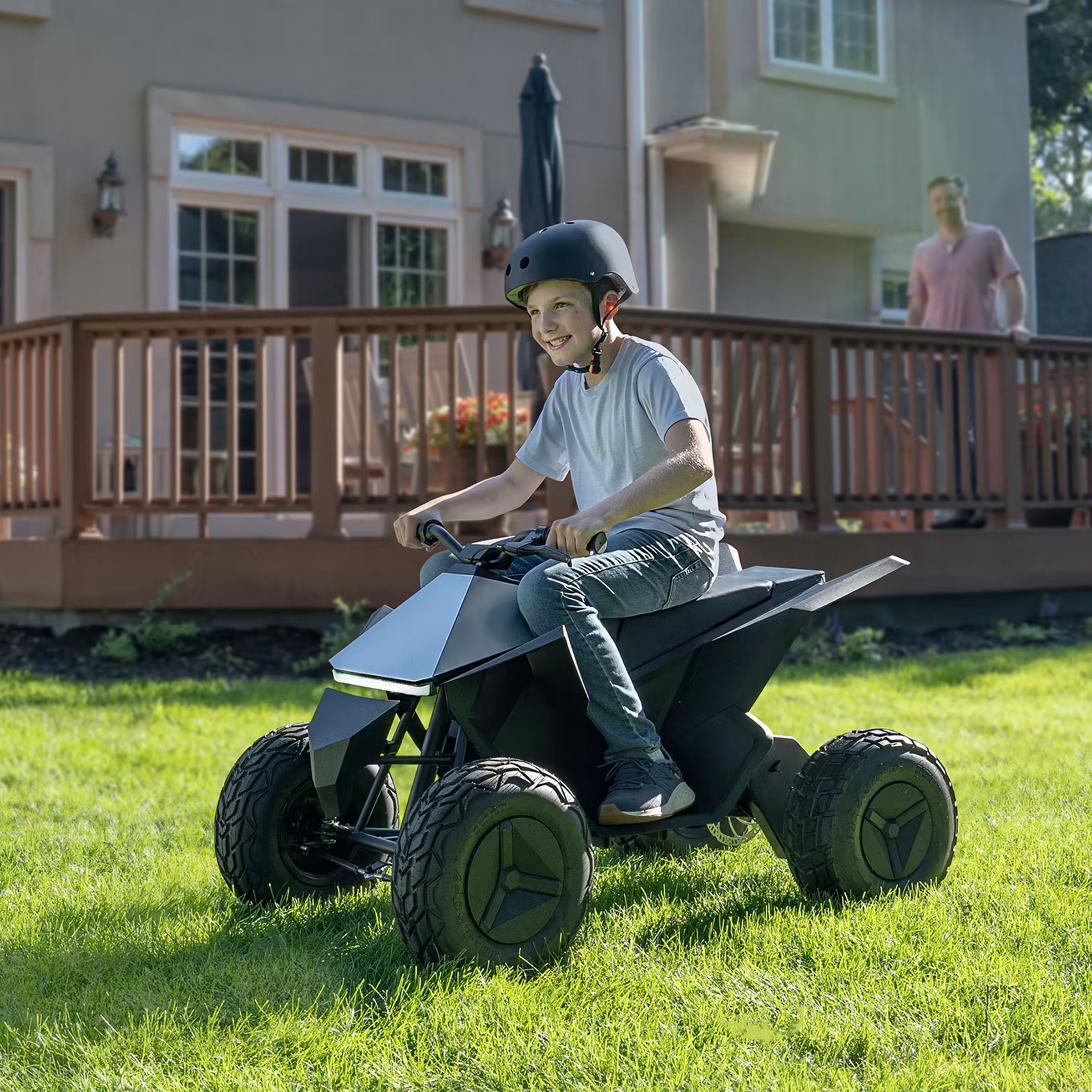 A child riding on a Cyberquad for Kids in a grassy garden.