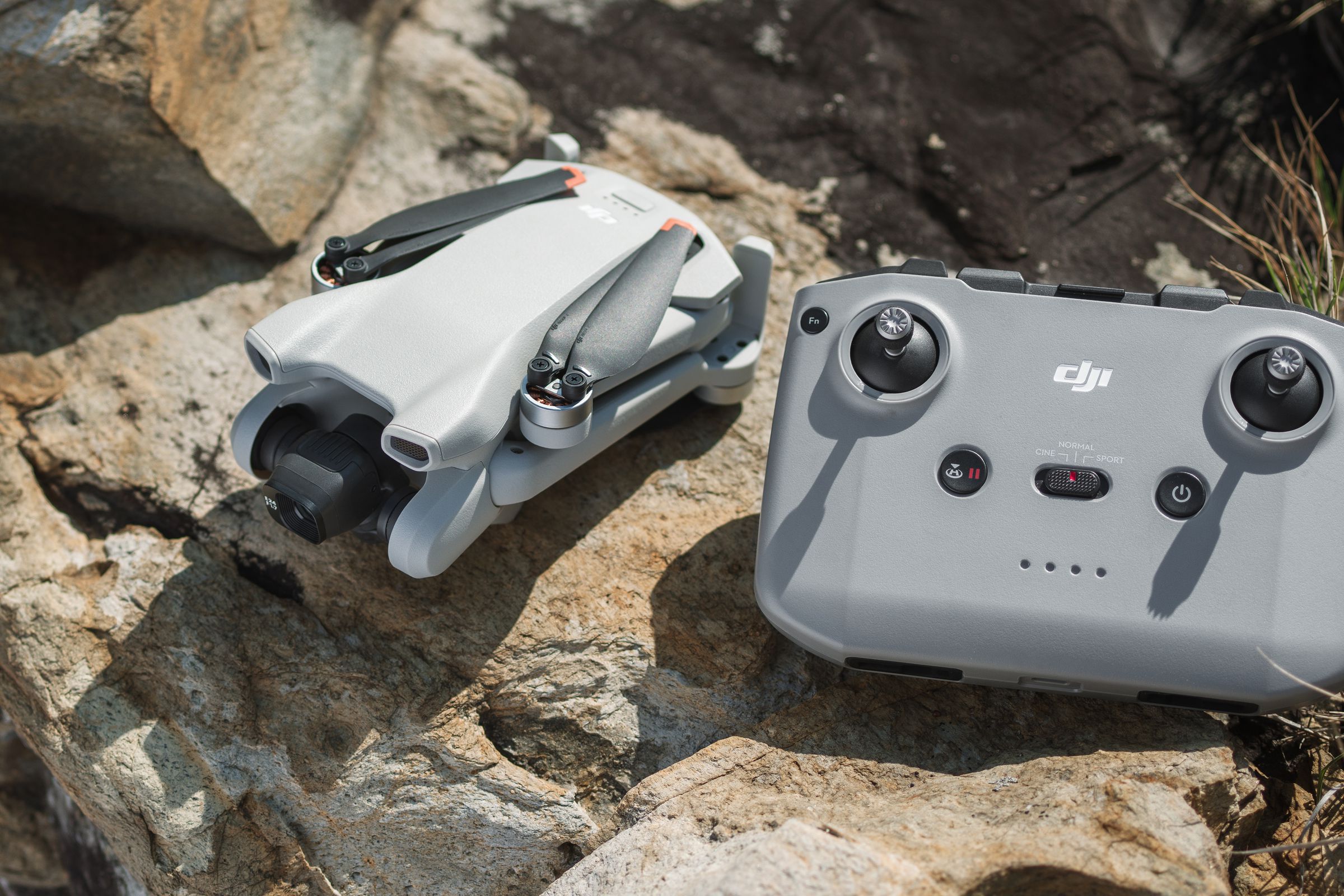 DJI Mini 3 drone and remote sitting on rocks